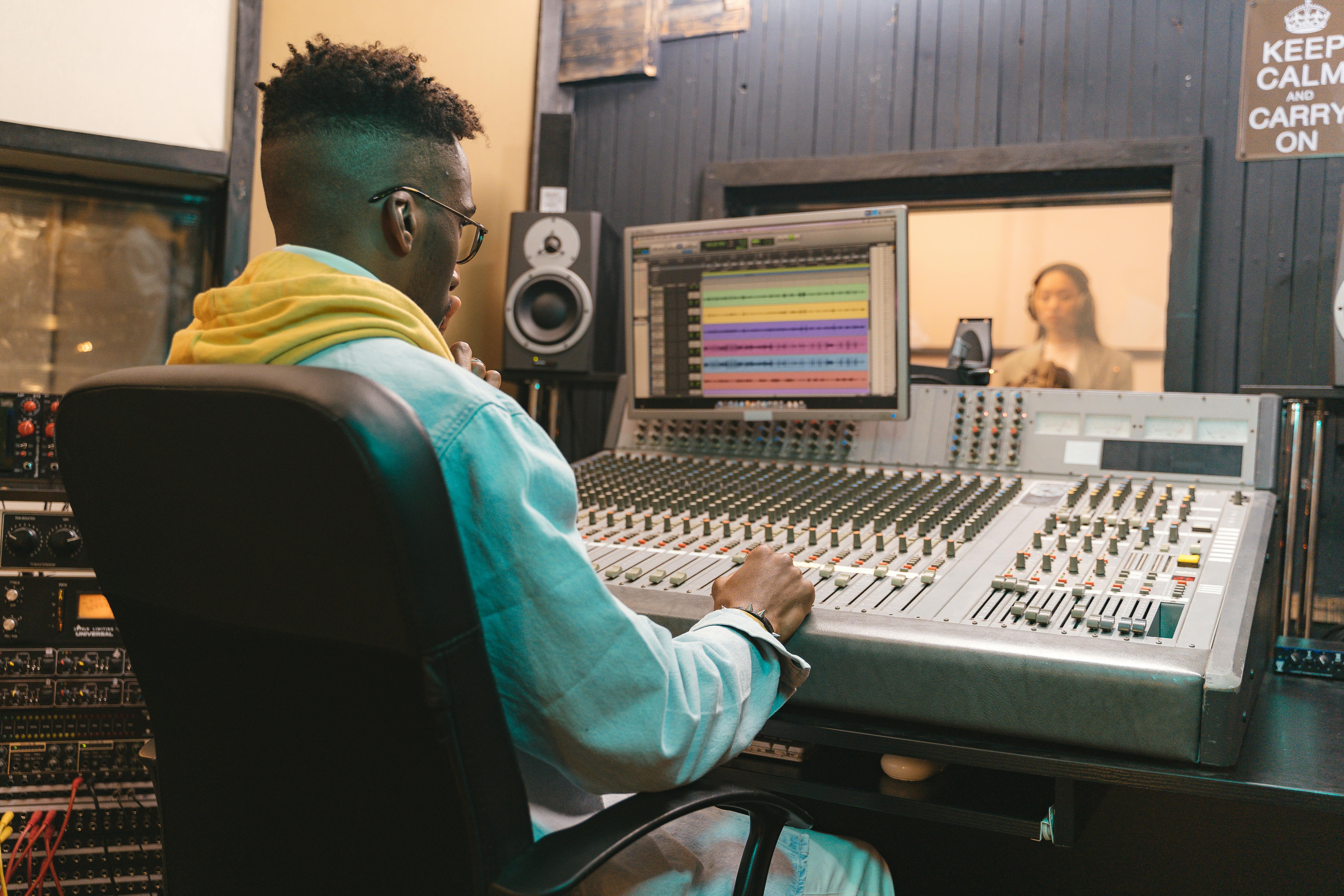 Close-Up Shot of a Music Producer Sitting on a Chair