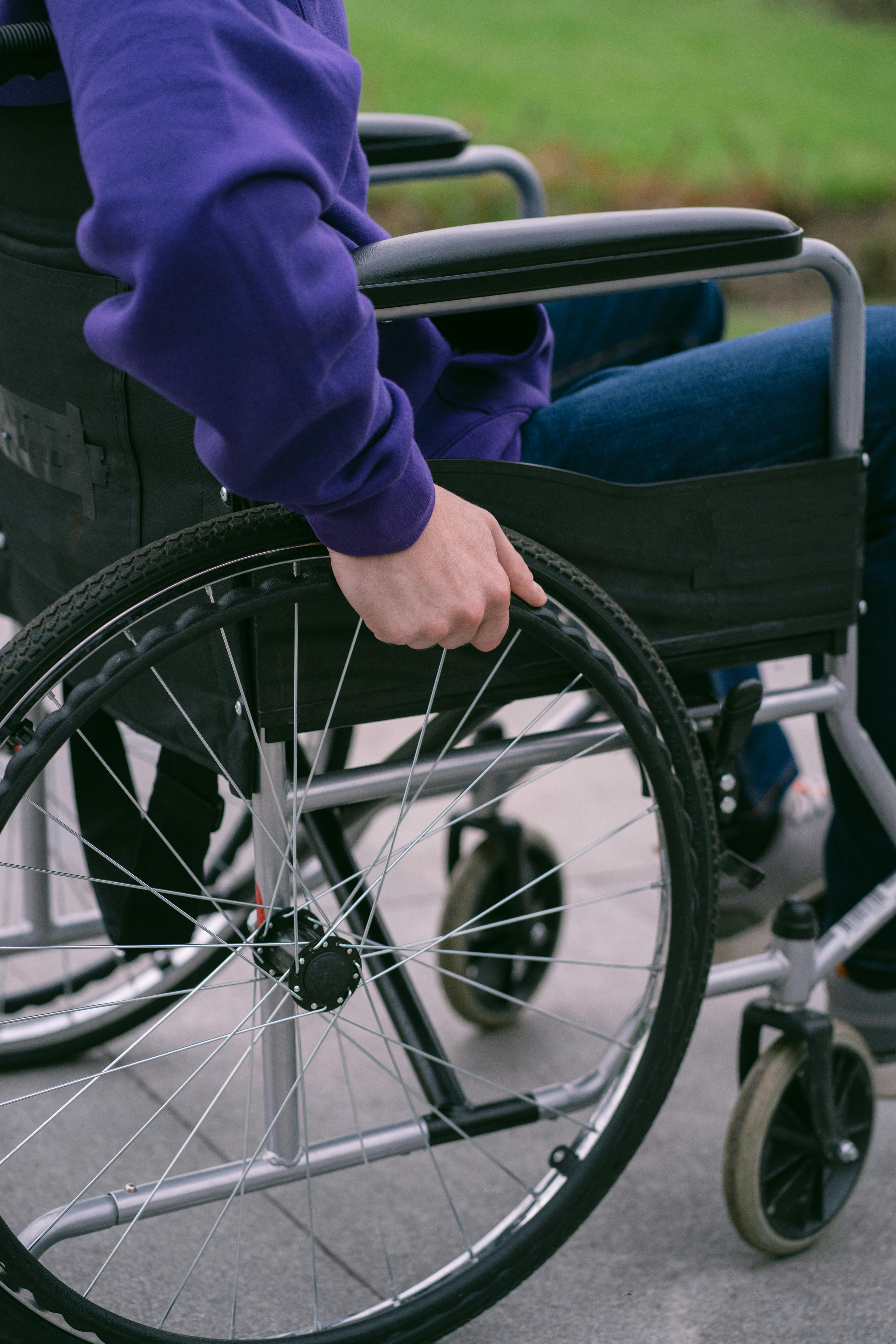 Close-Up Shot of a Person Sitting on a Wheelchair