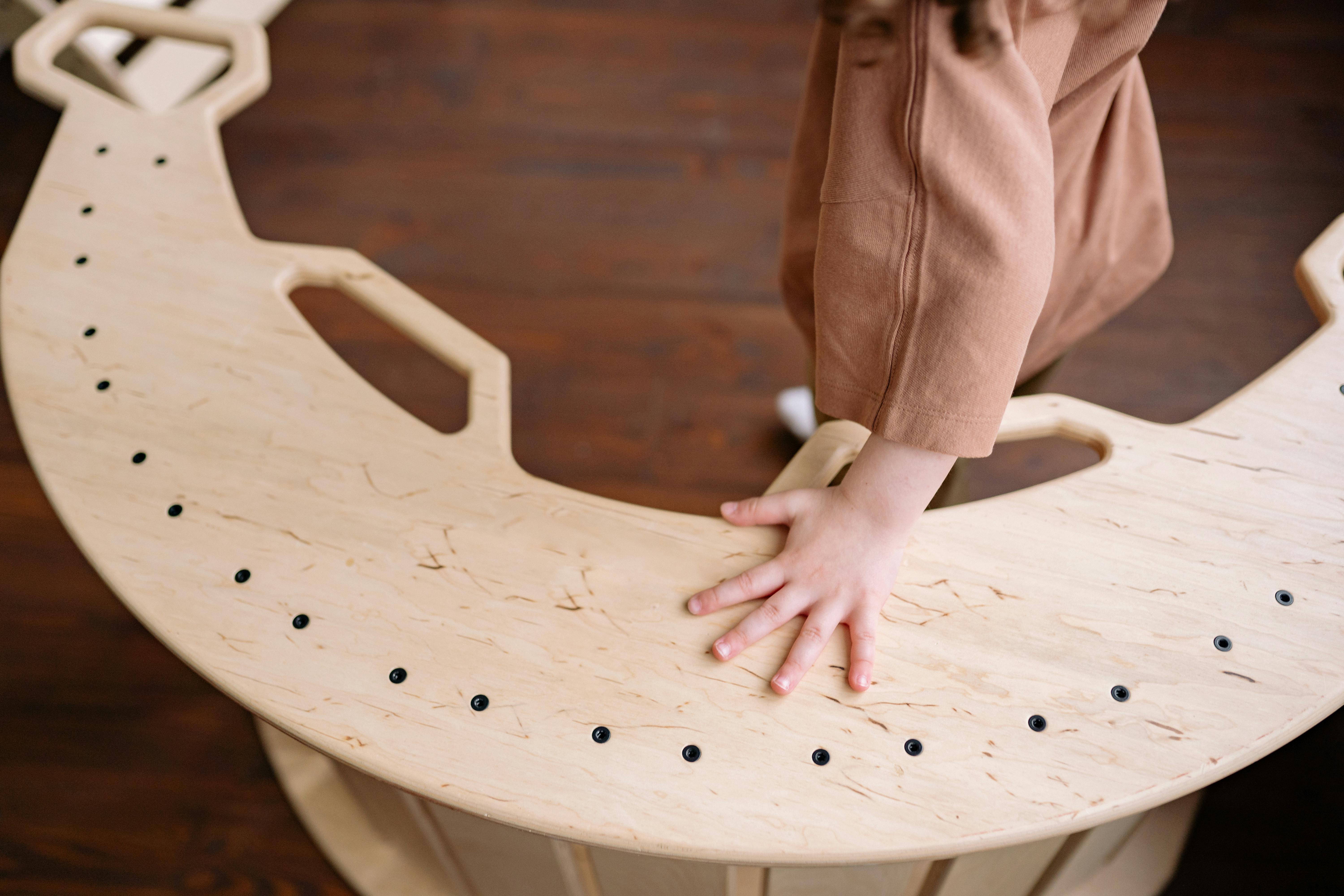 A Child Holding a Wood