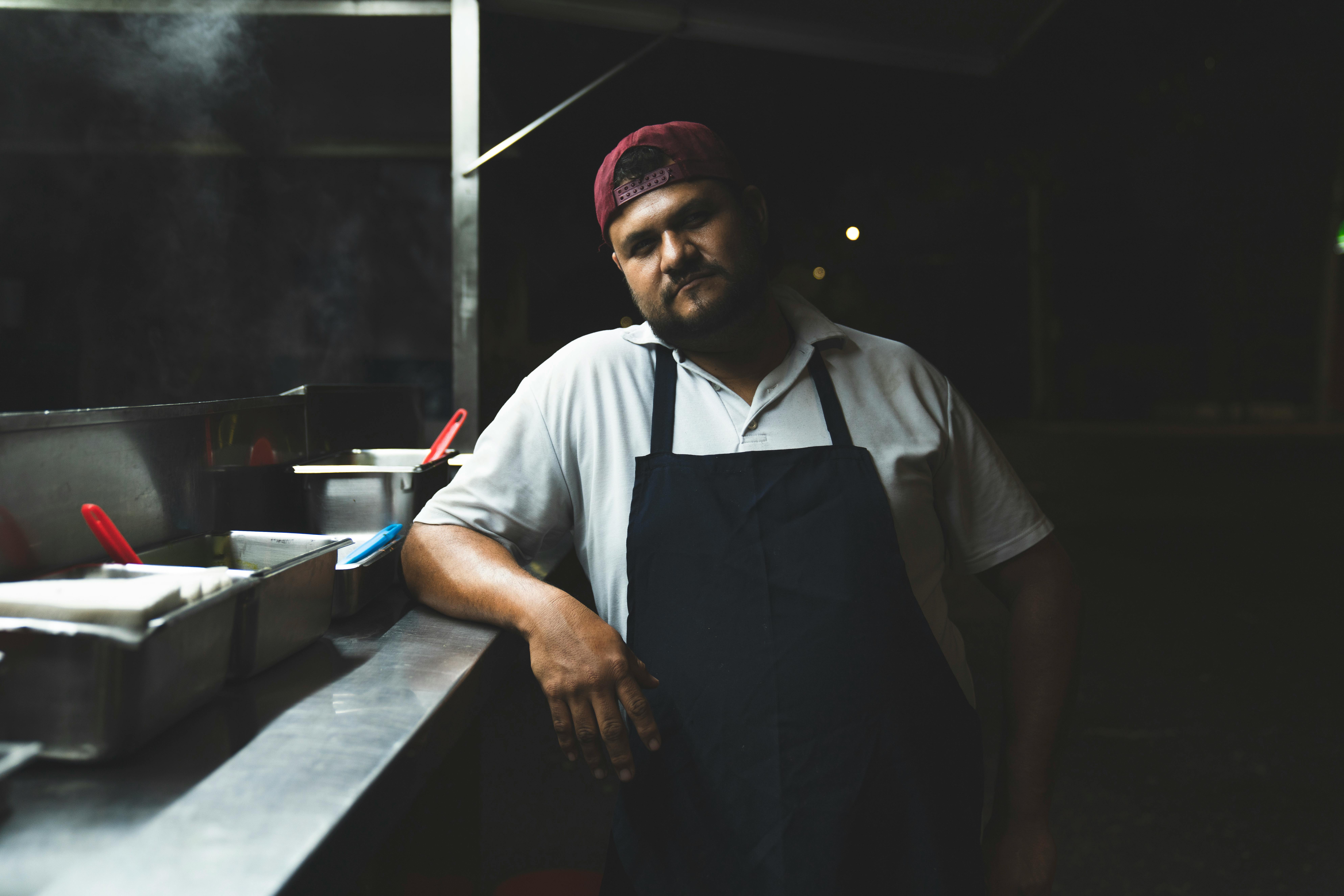 Man in Black Apron and Cap