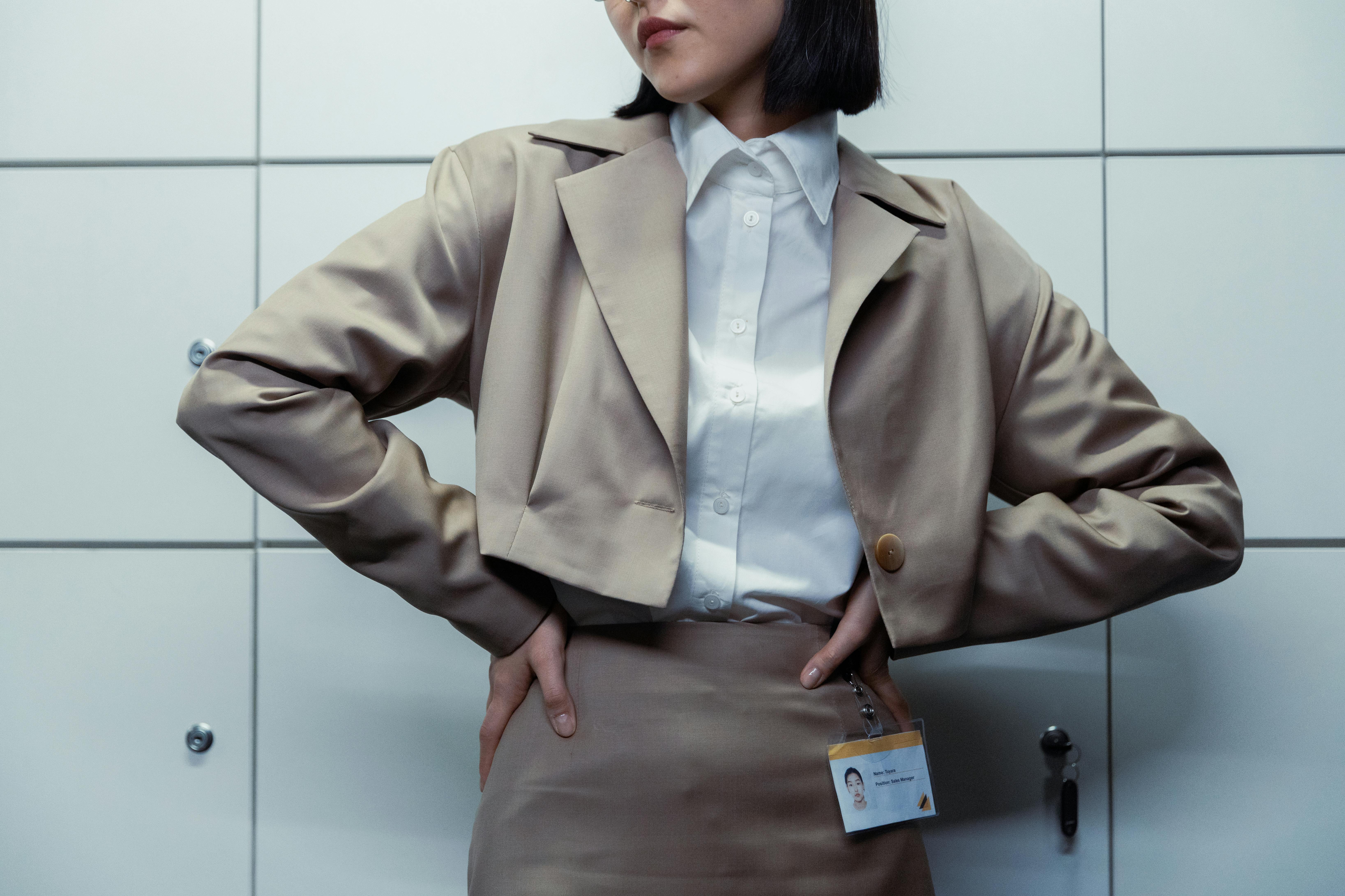 Woman in Brown Blazer With Hands on Her Waist