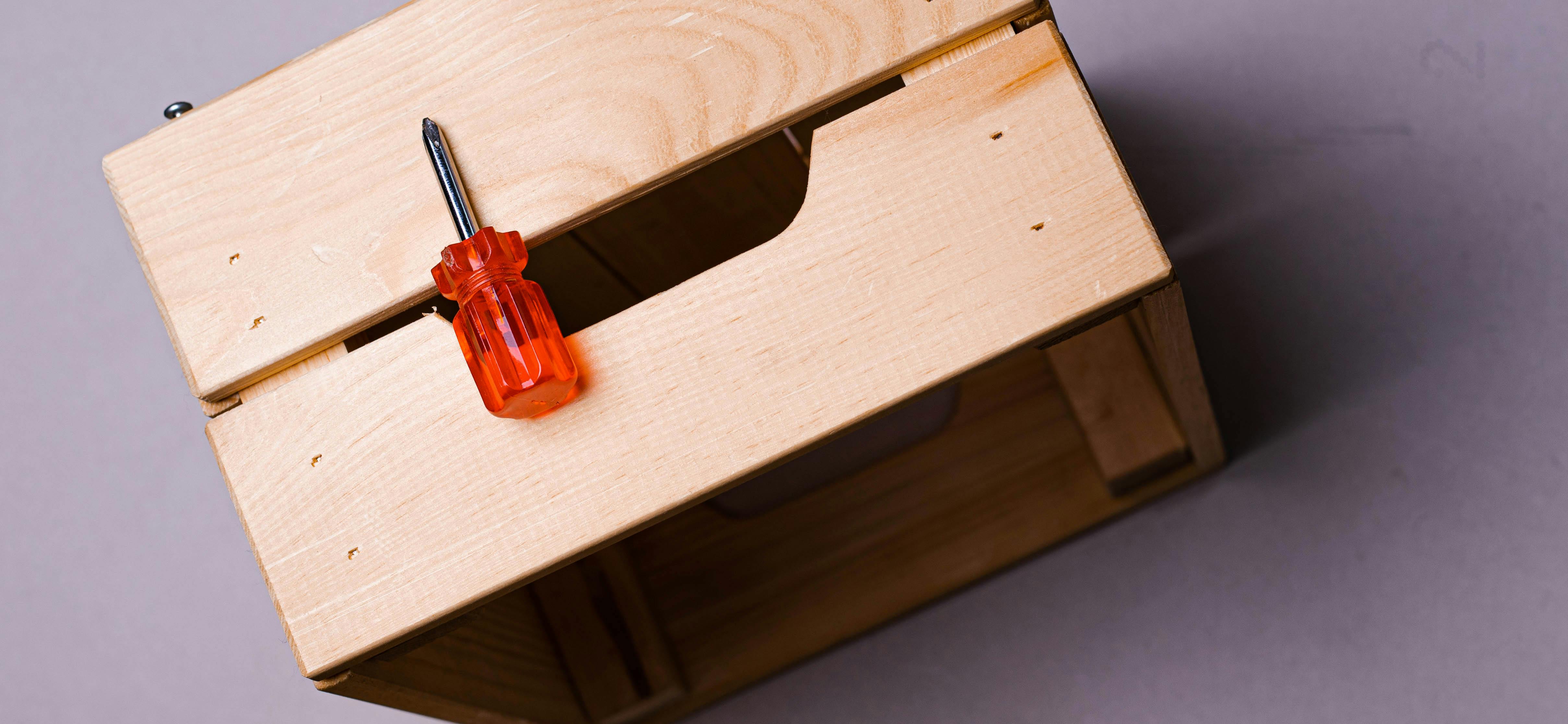 Overhead Shot of Small Screwdriver on a Wooden Crate