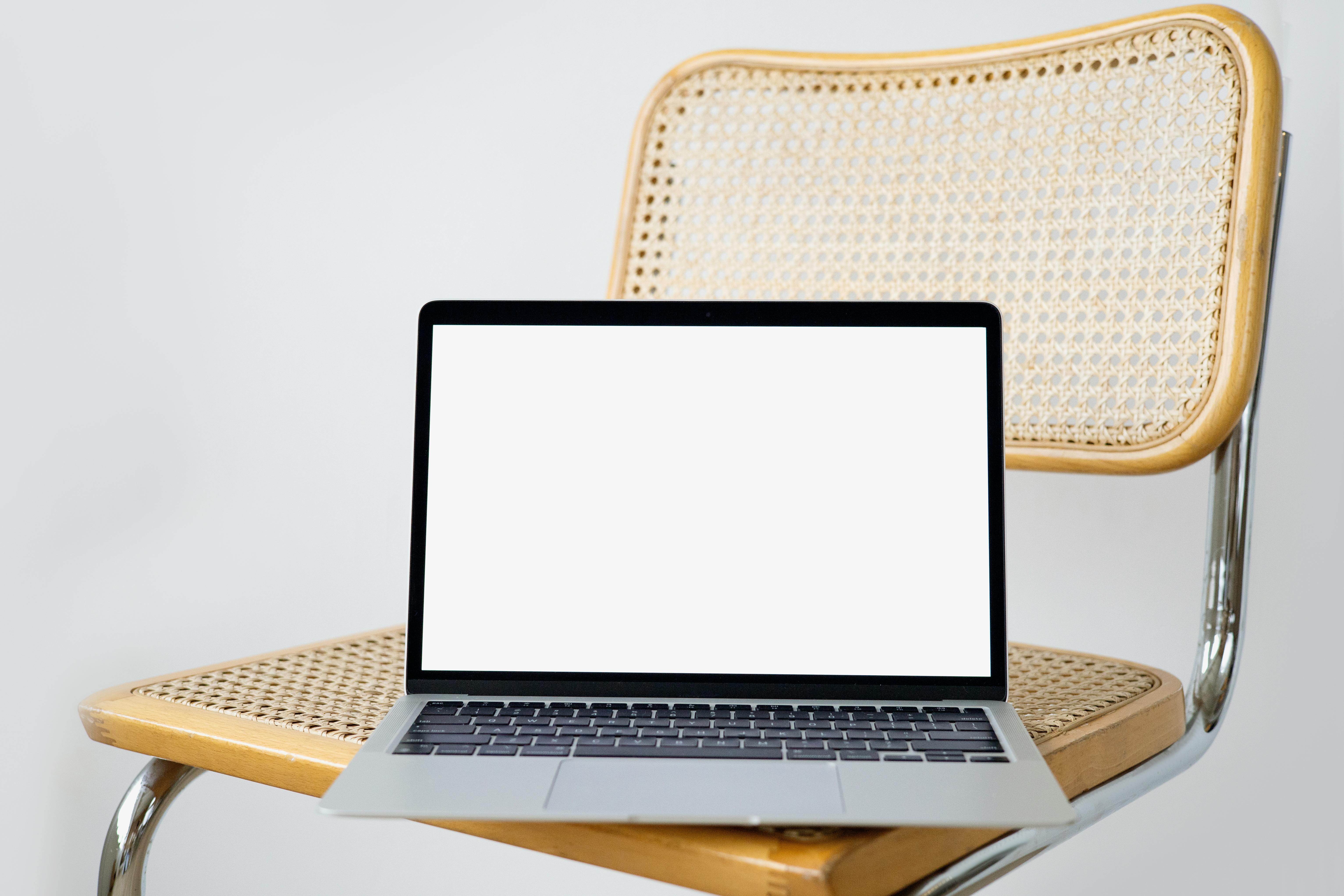 A Laptop on a Woven Chair