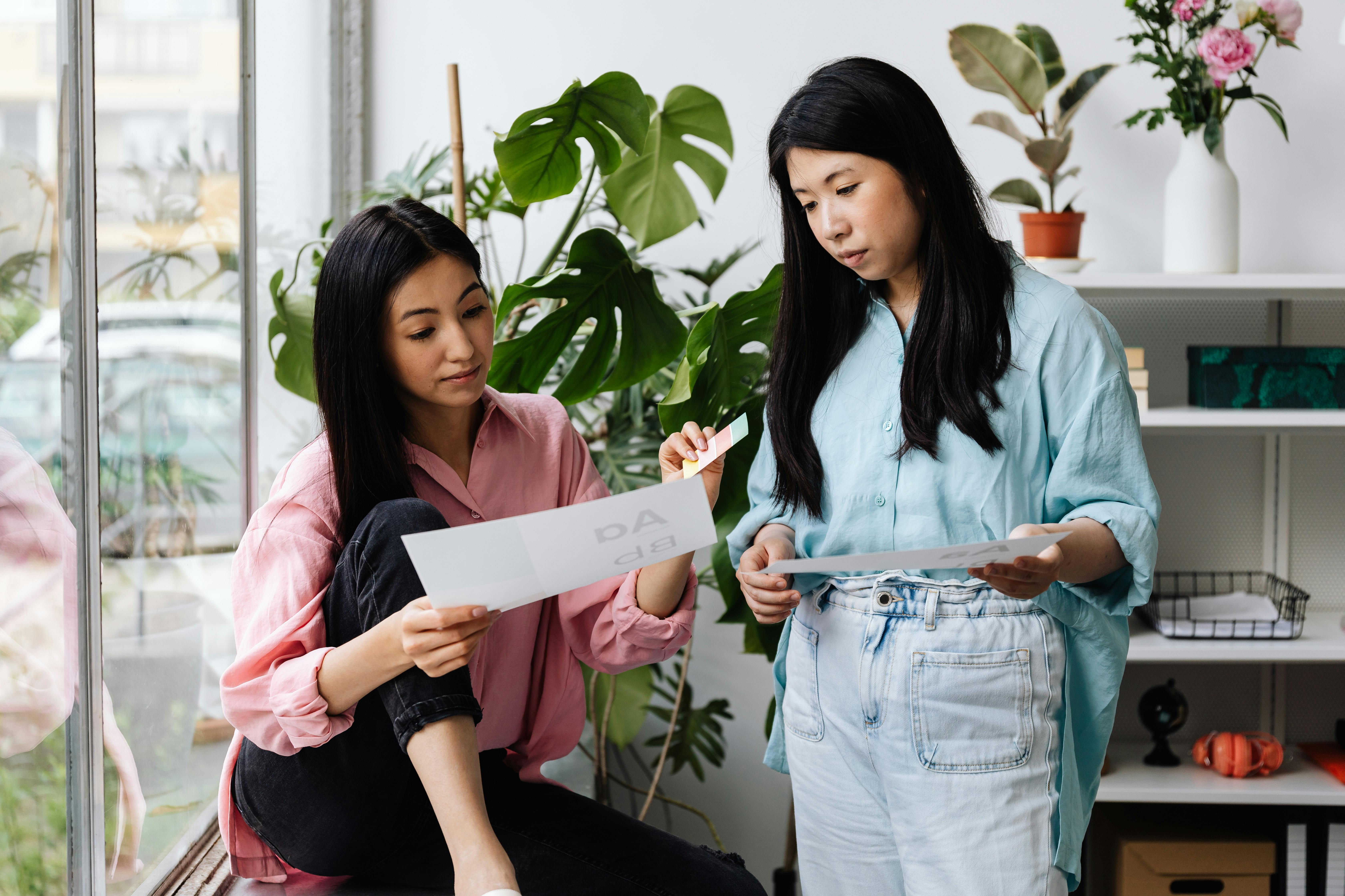Two Women Looking at the Paper