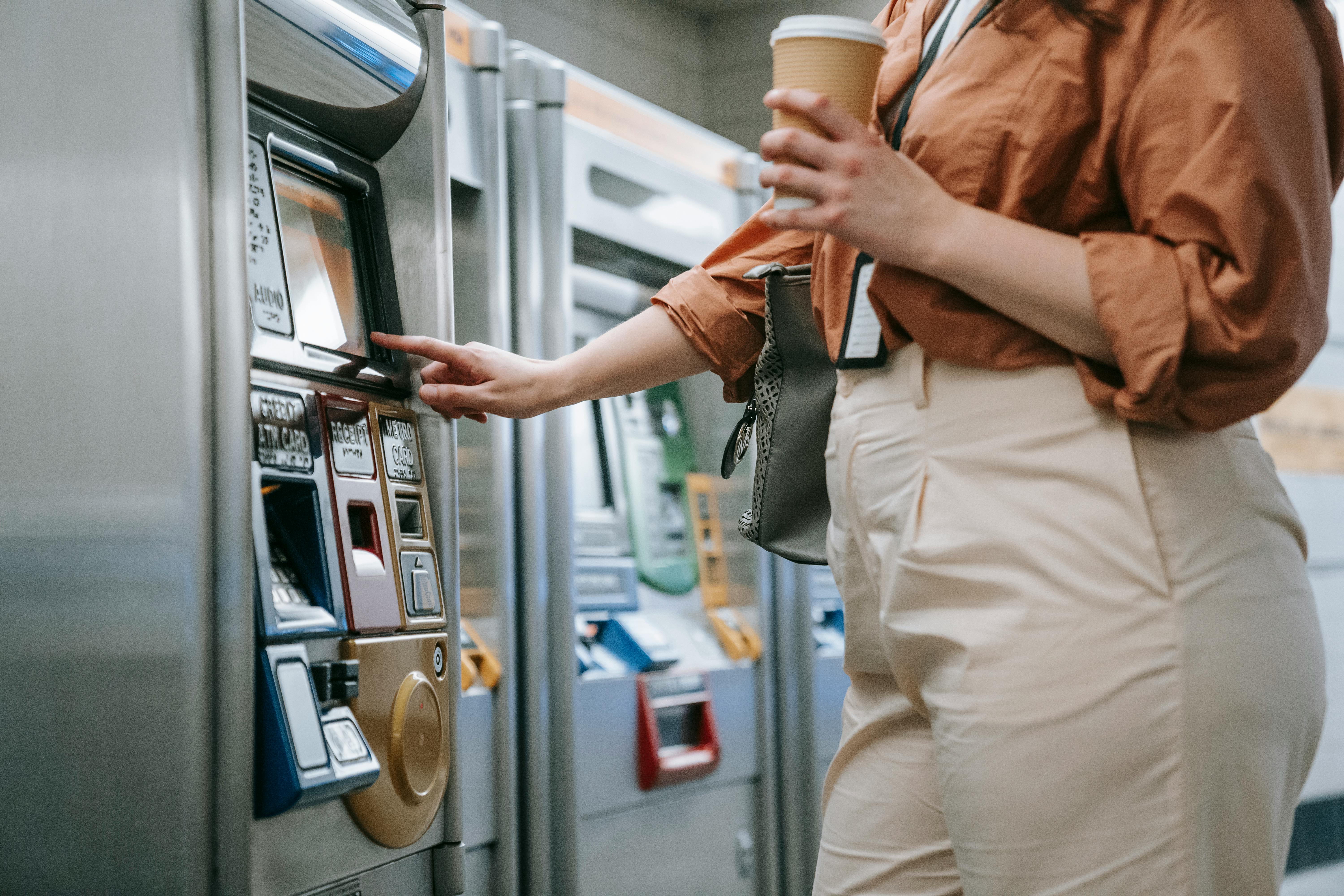 Close-up of Woman Buying a Ticket in a Ticket Machine