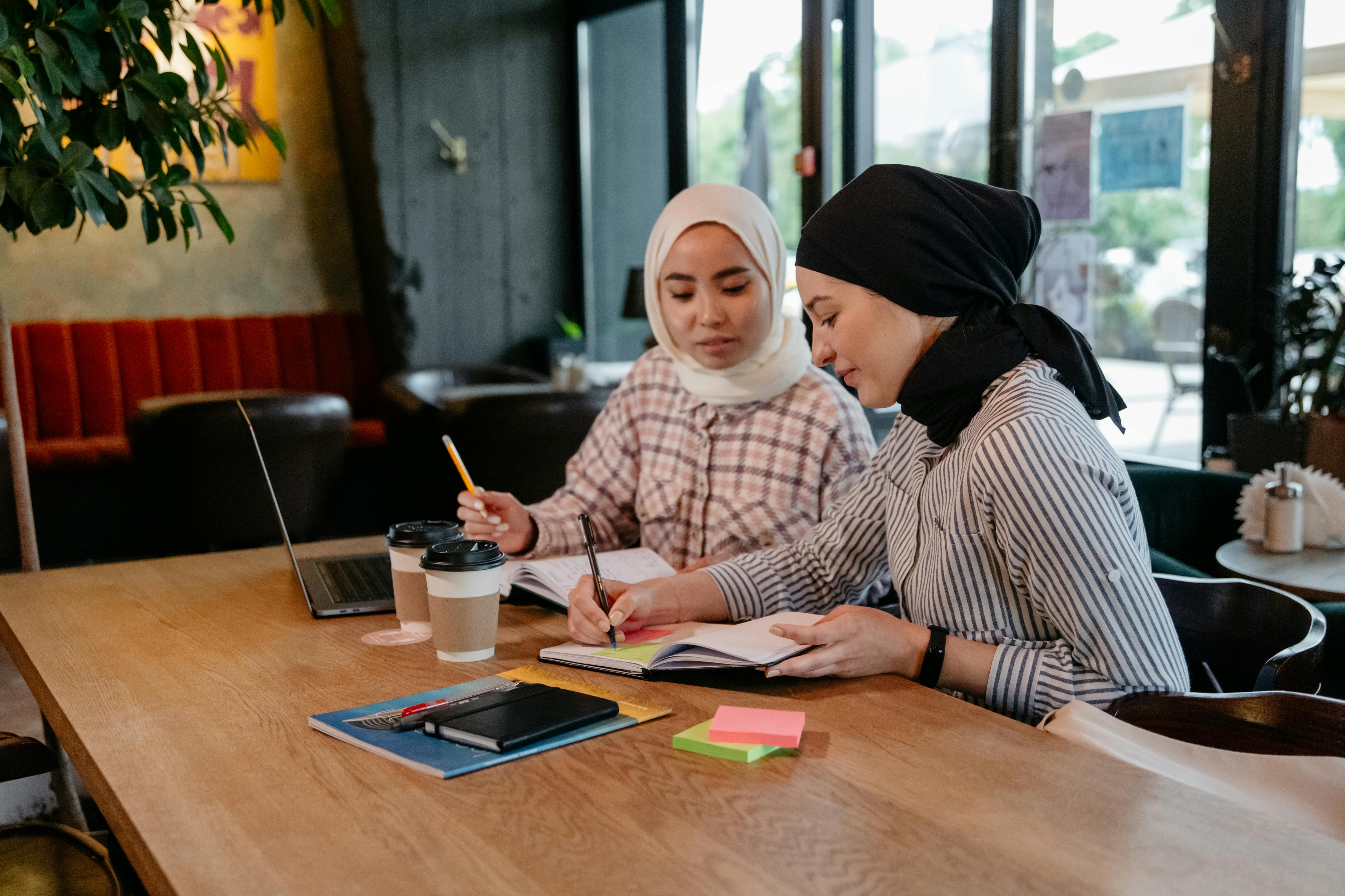 Women Sitting at Cafe and Studying
