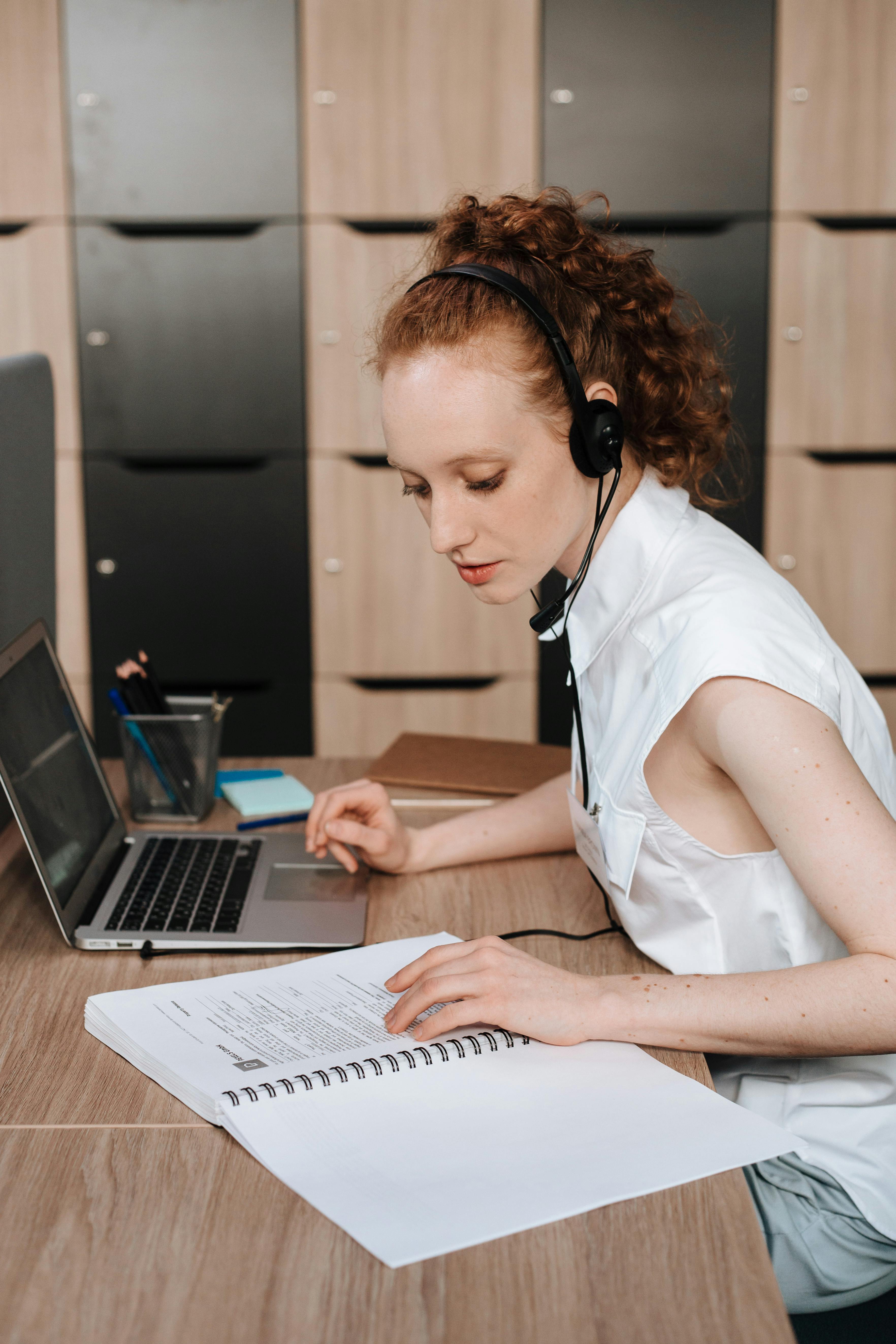 Woman in White Shirt Using Macbook Pro