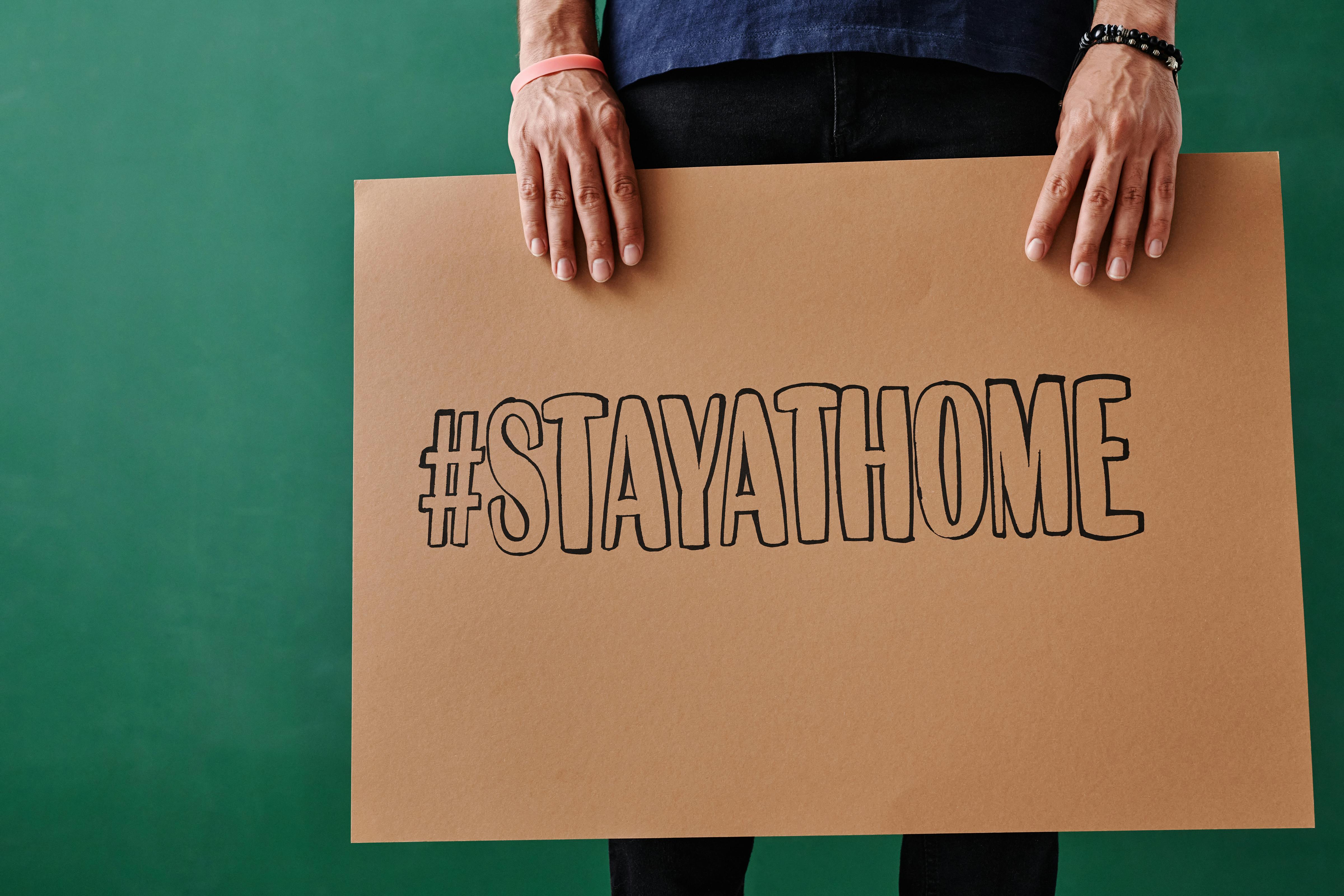 Person Holding a Brown Cardboard