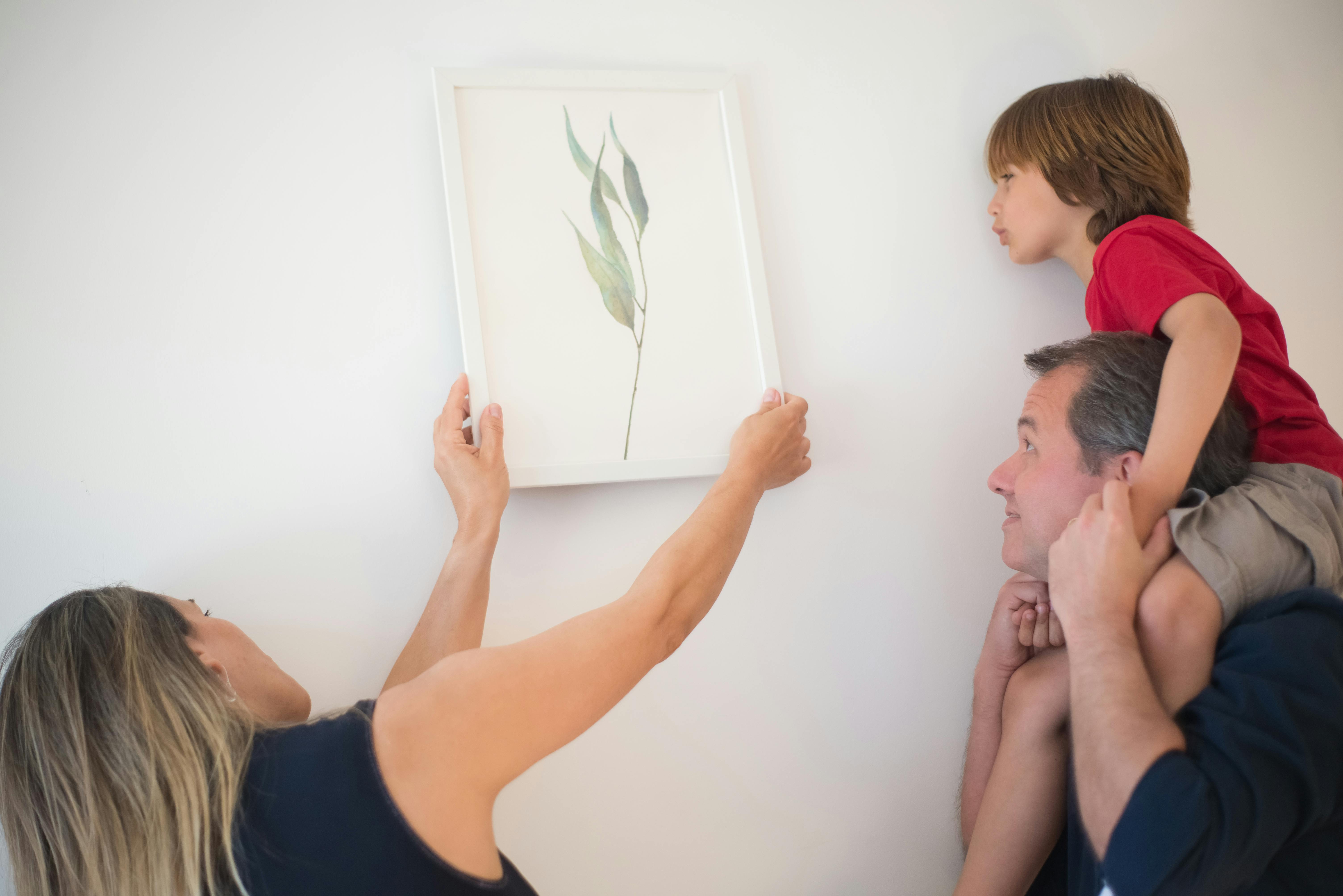 Woman Putting Wall Art on the Wall