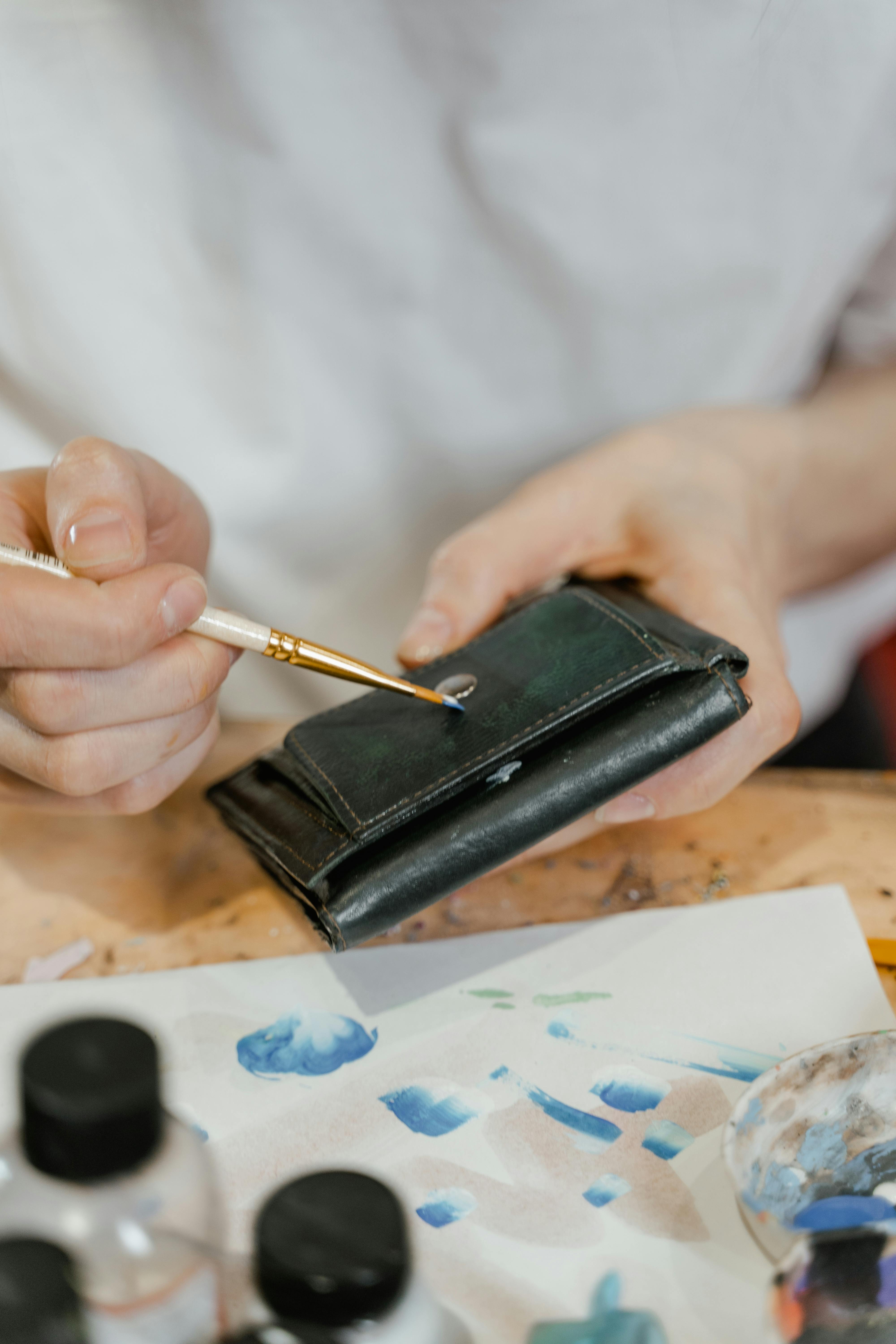 A Person Holding a Black Leather Wallet