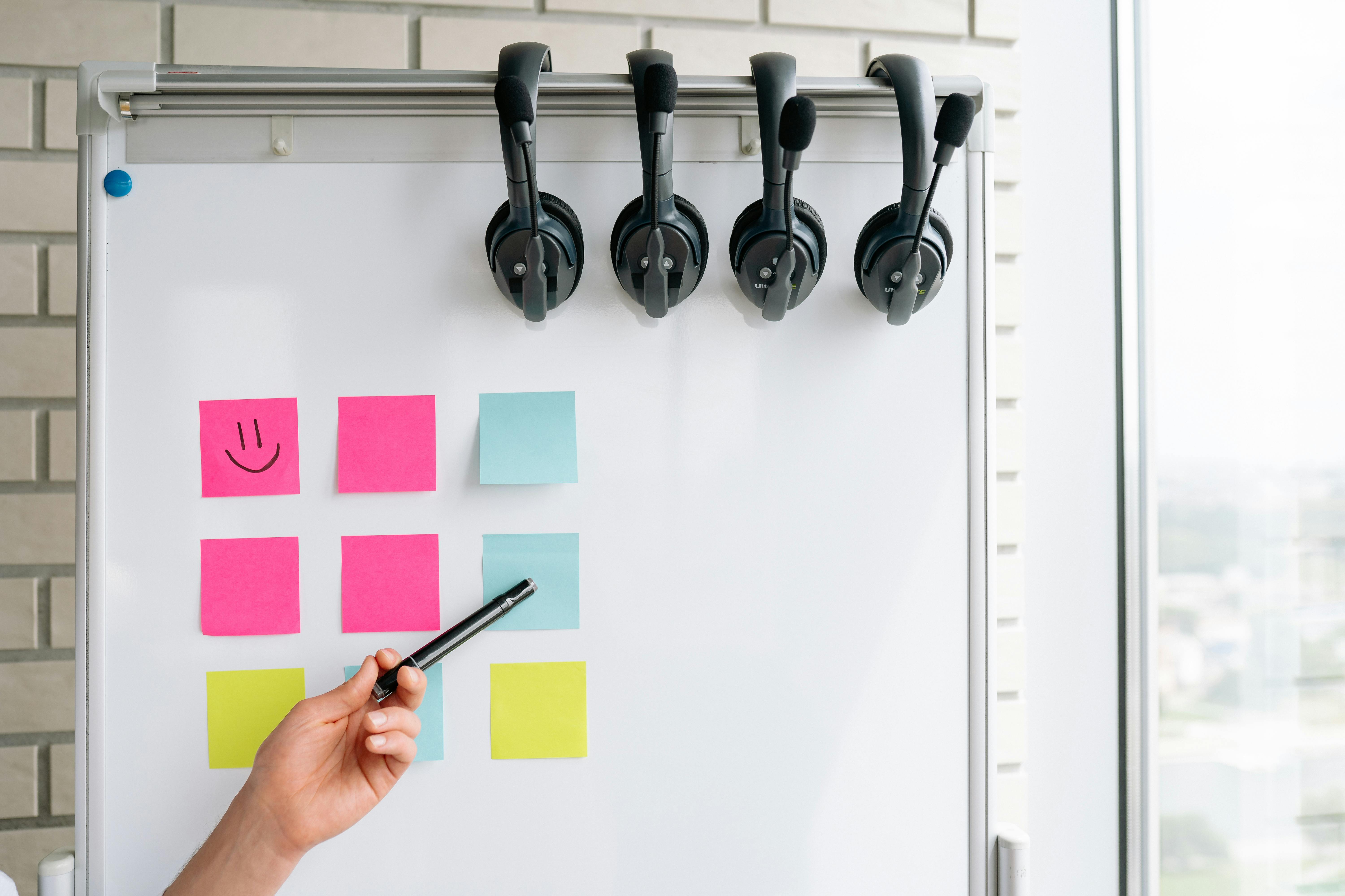 Whiteboard with Sticky Notes and Headsets