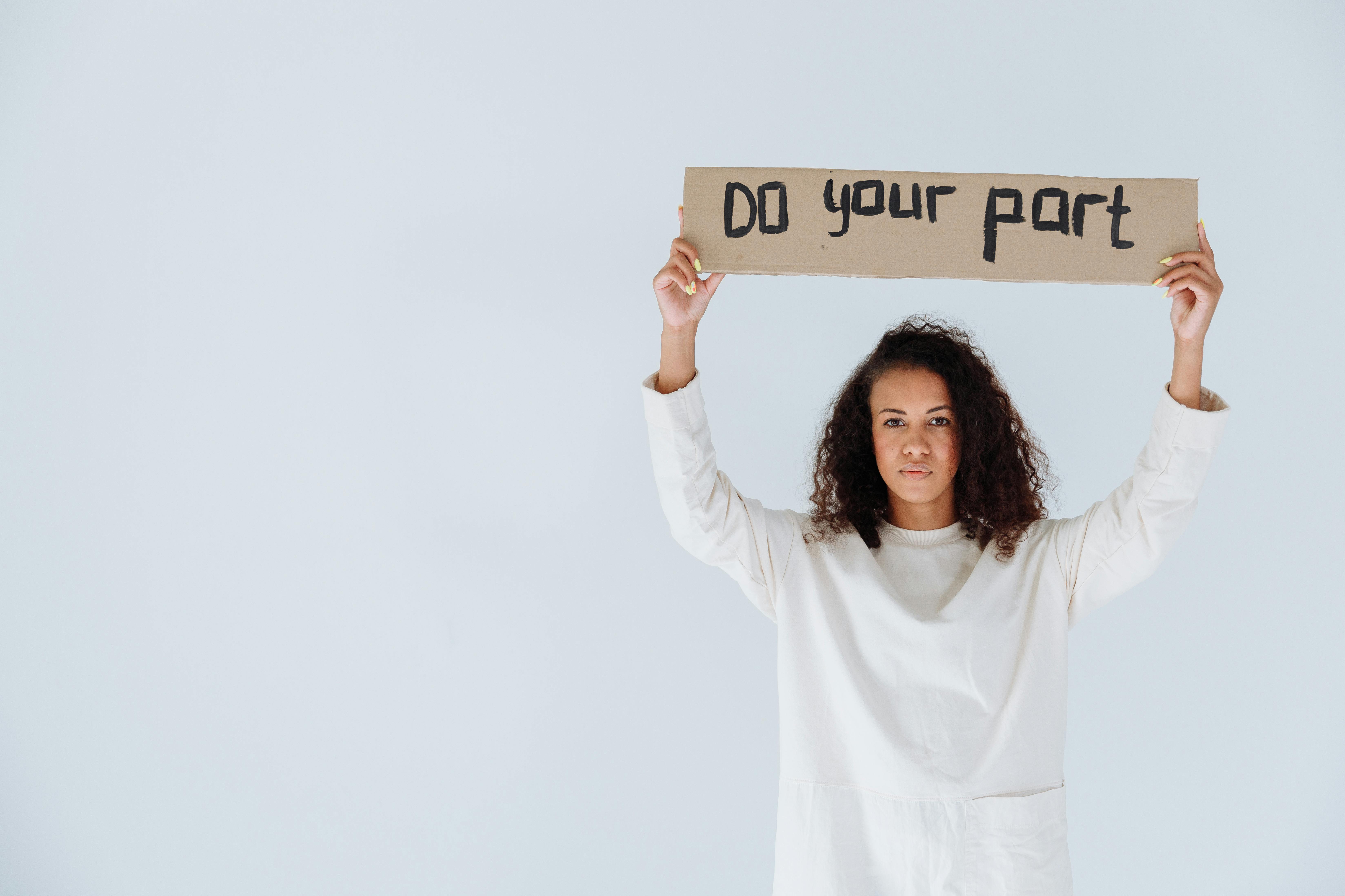 Woman Arms Raised Holding a Sign