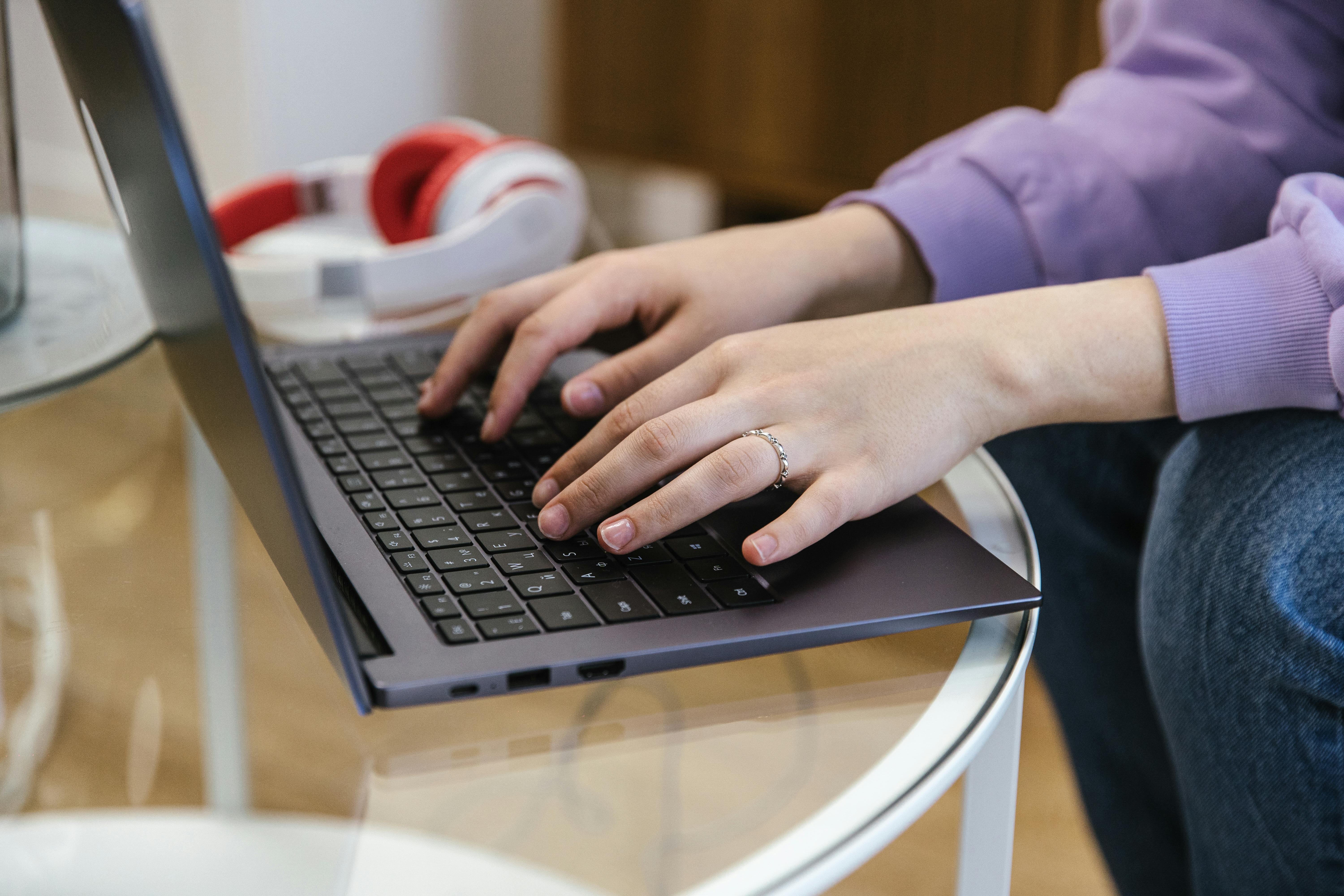 A Person Typing on the Laptop