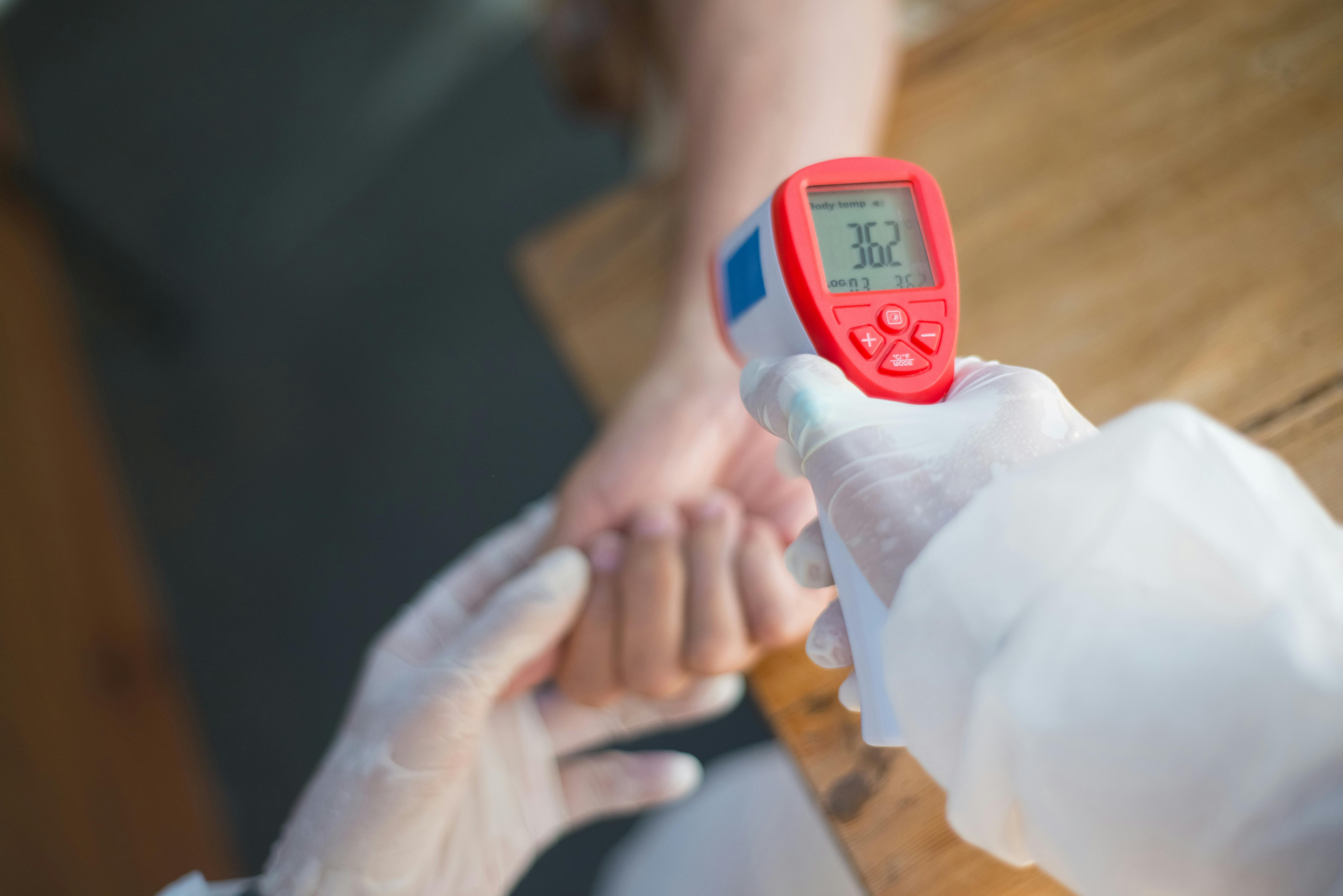 A Person Holding an Infrared Thermometer