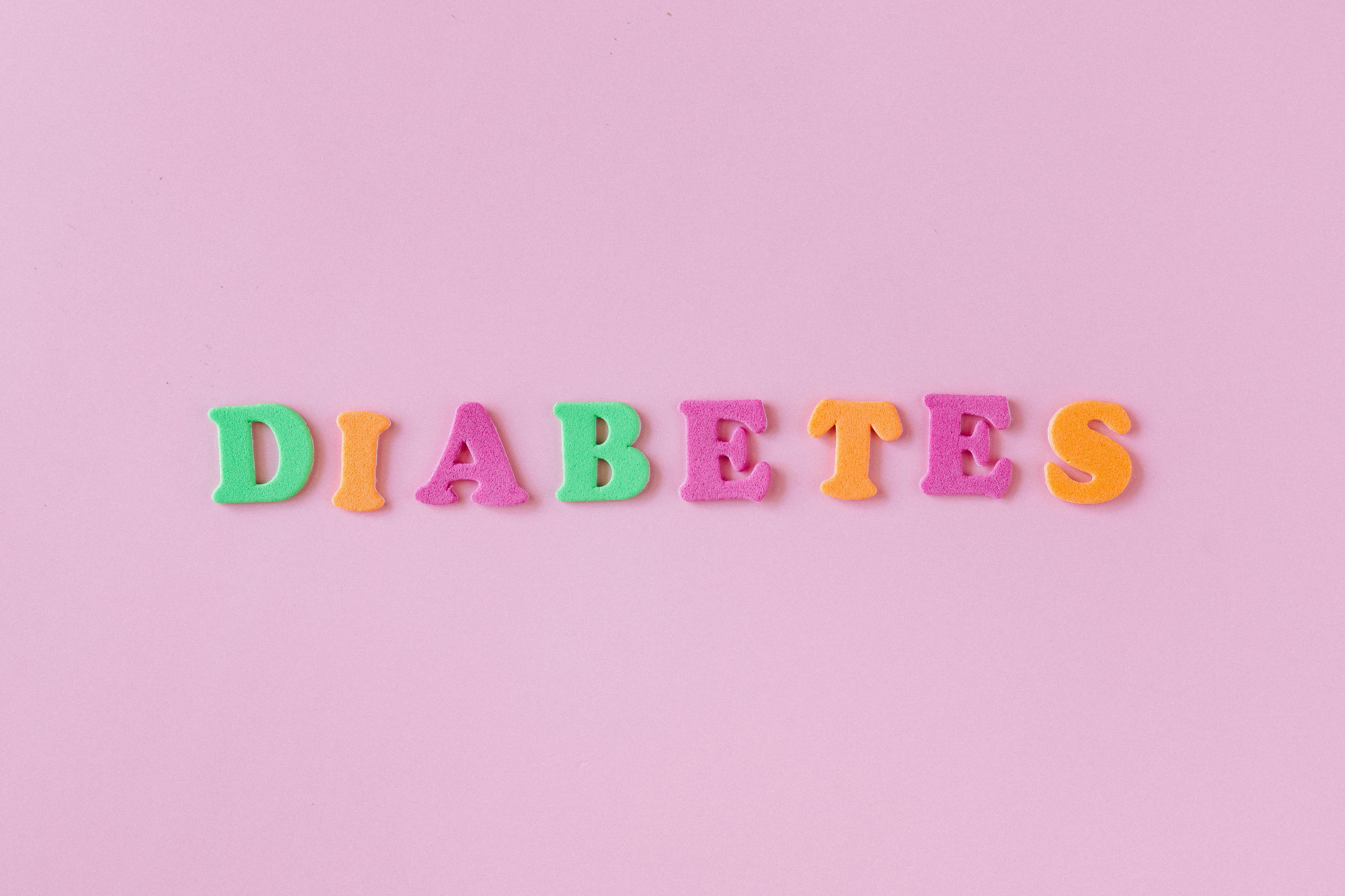 Colorful Letters on a Pink Background Creating a Word Diabetes