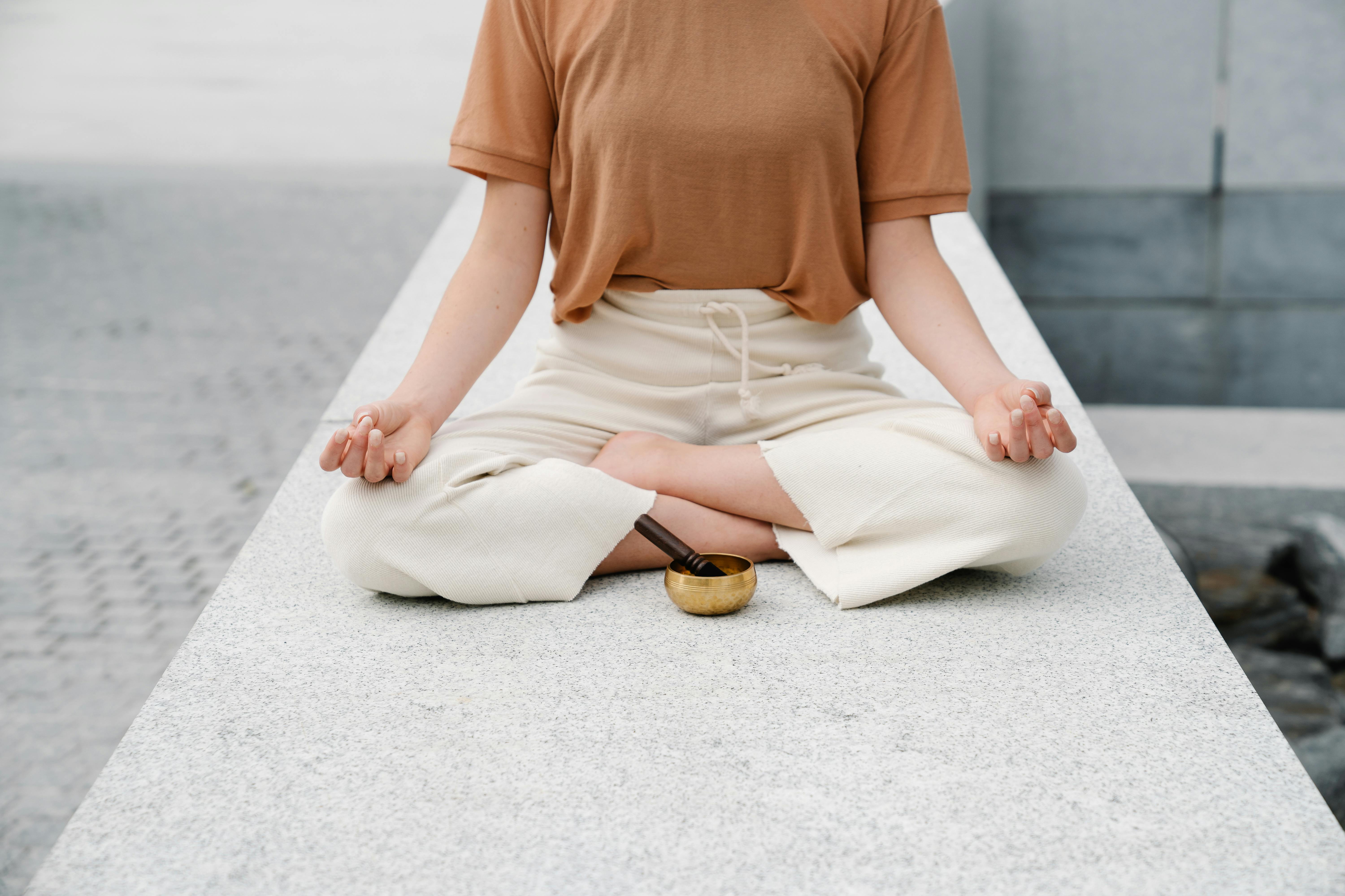 A Woman Meditating with a Singing Bowl