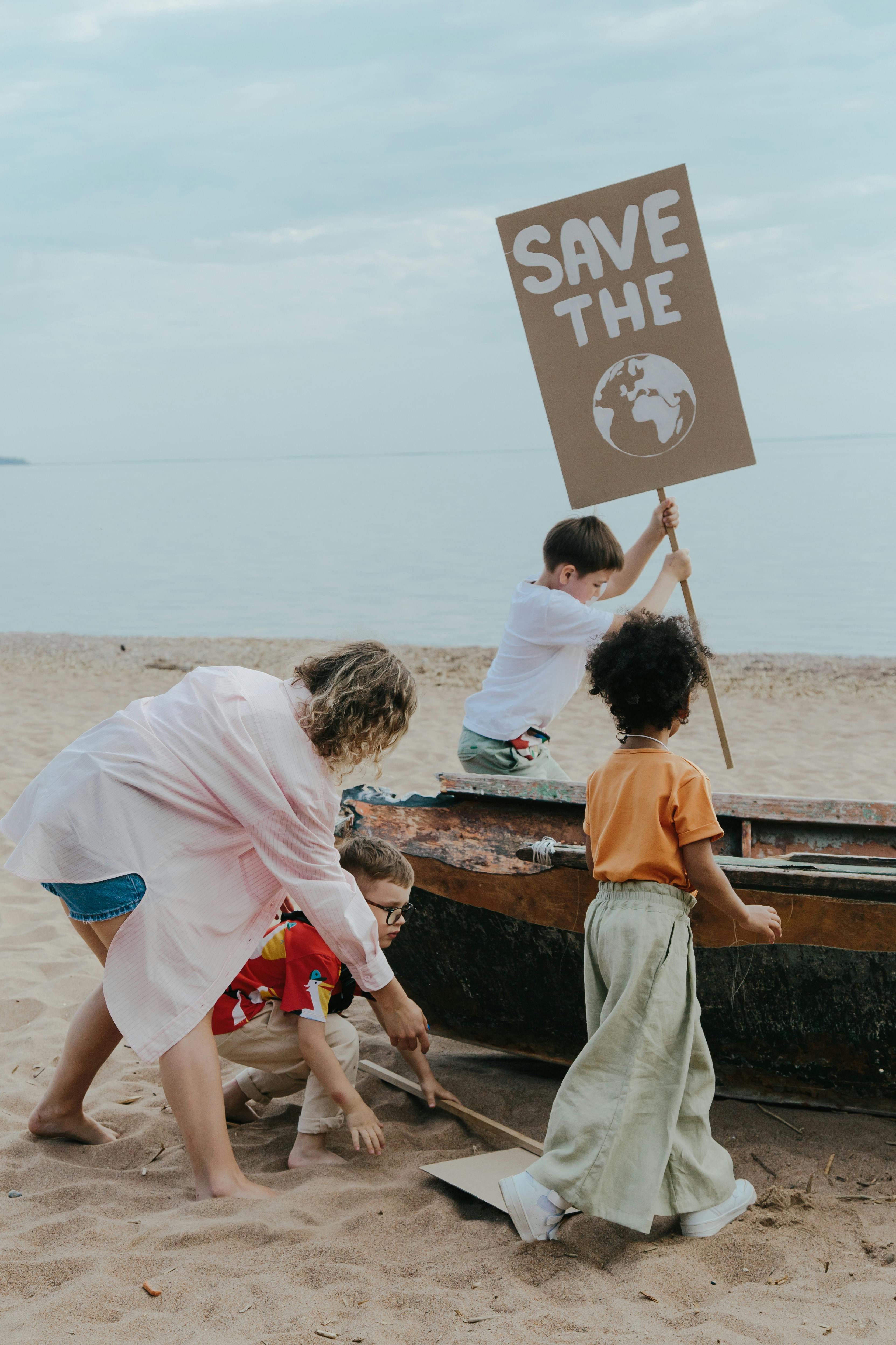 Children Standing on Brown Sand beside Brown Wooden Boat