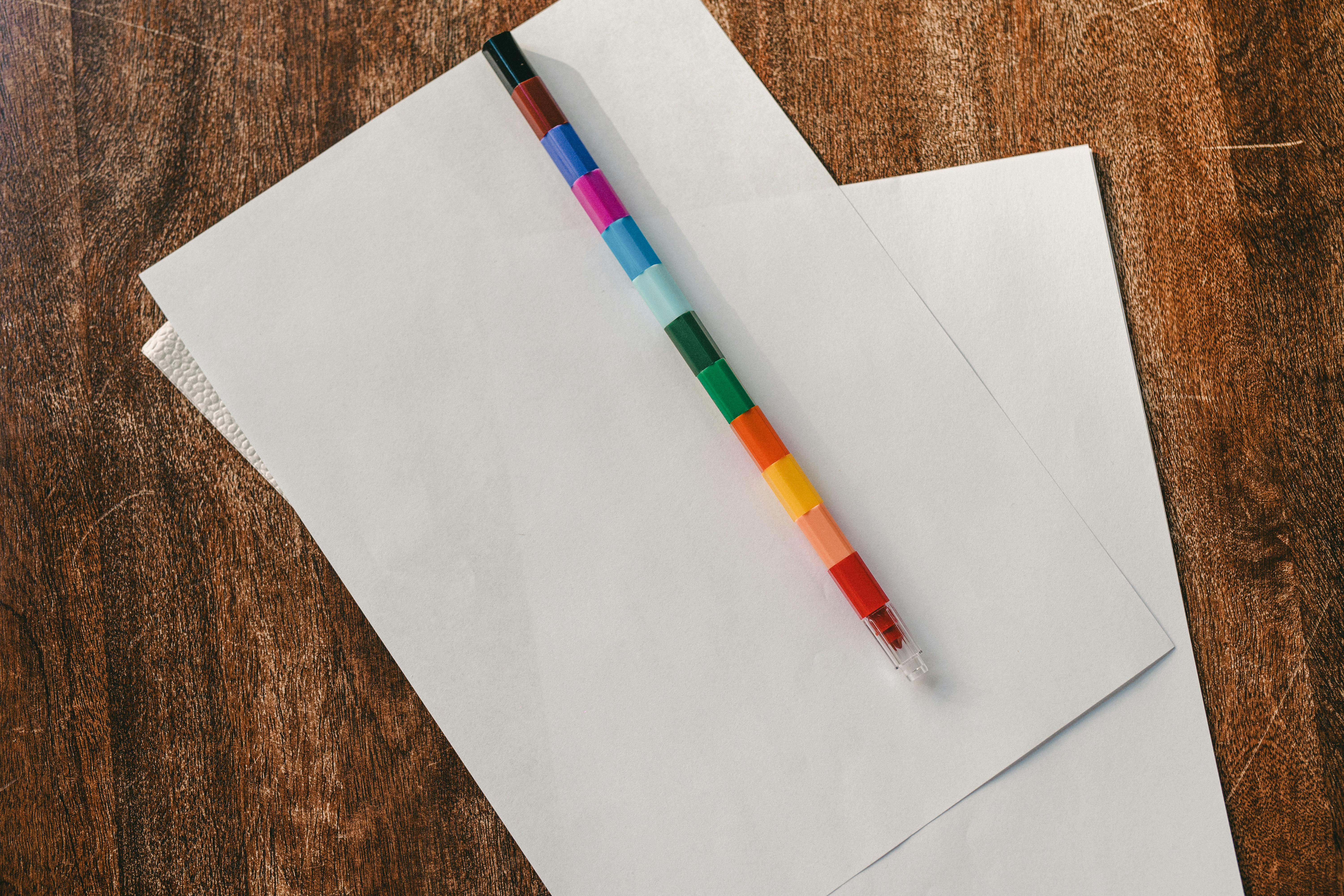 A Rainbow Pencil on White Printer Papers