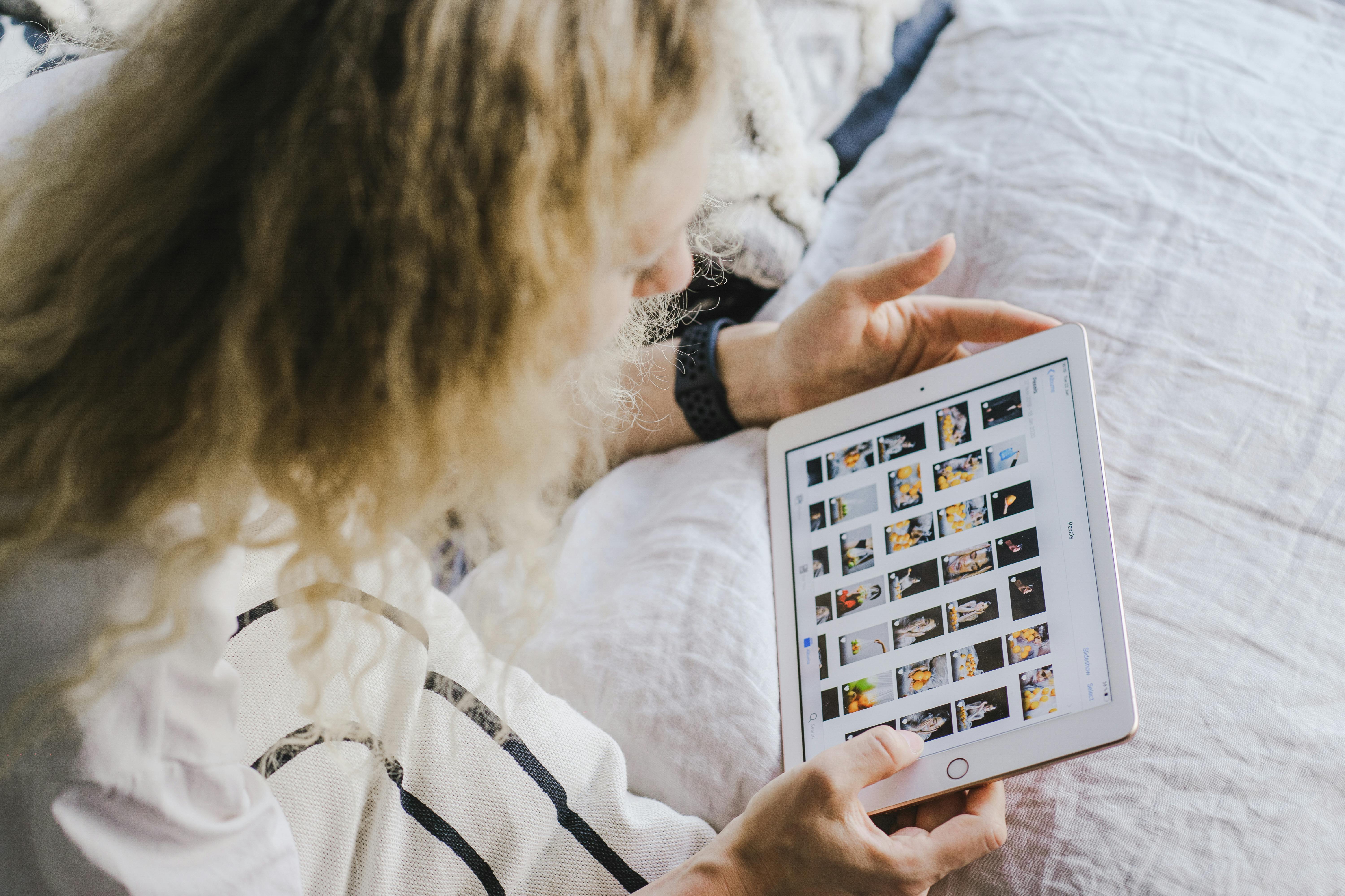 A Woman Using a White Ipad