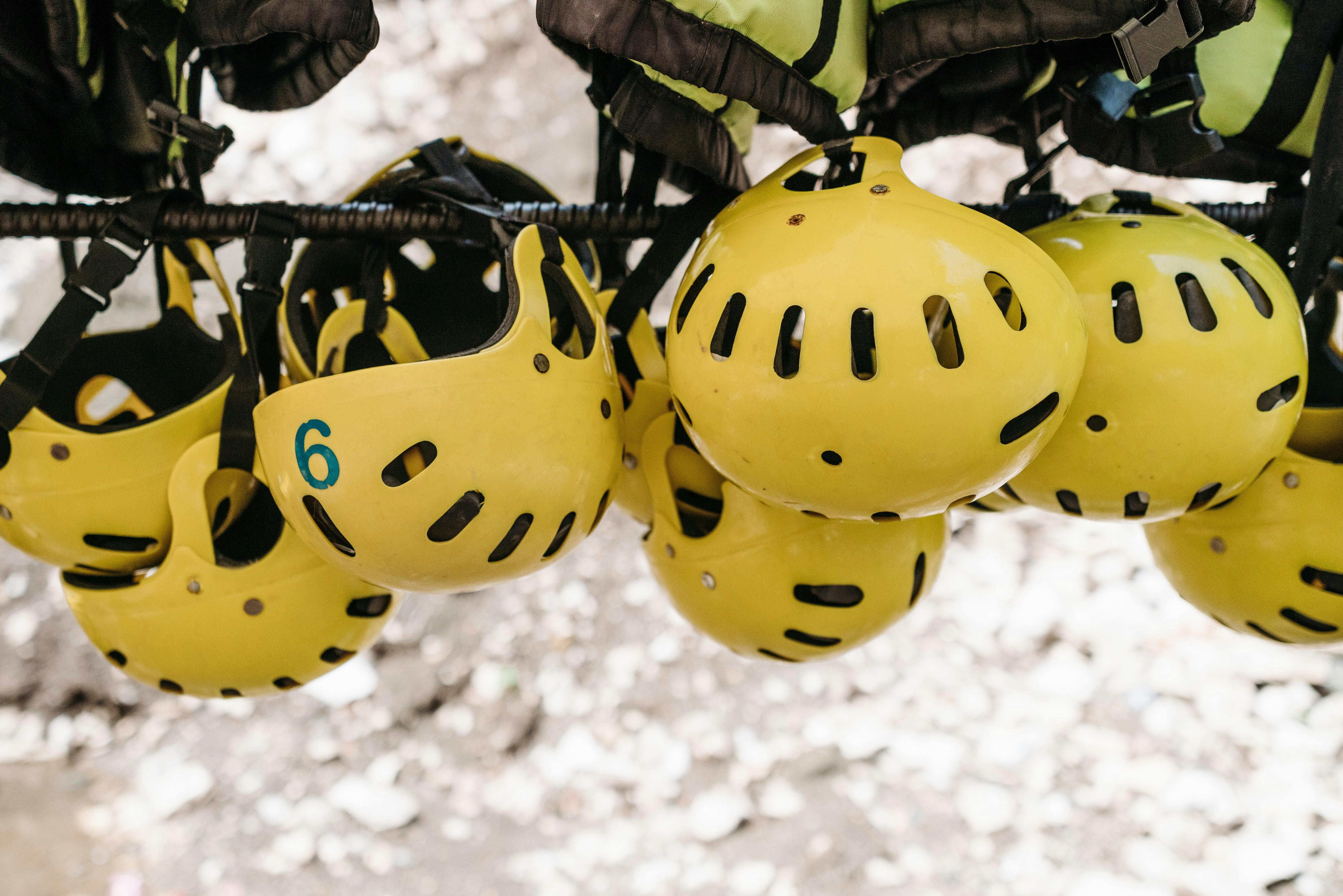 Yellow Protective Helmets Hanging on a Metal Rack