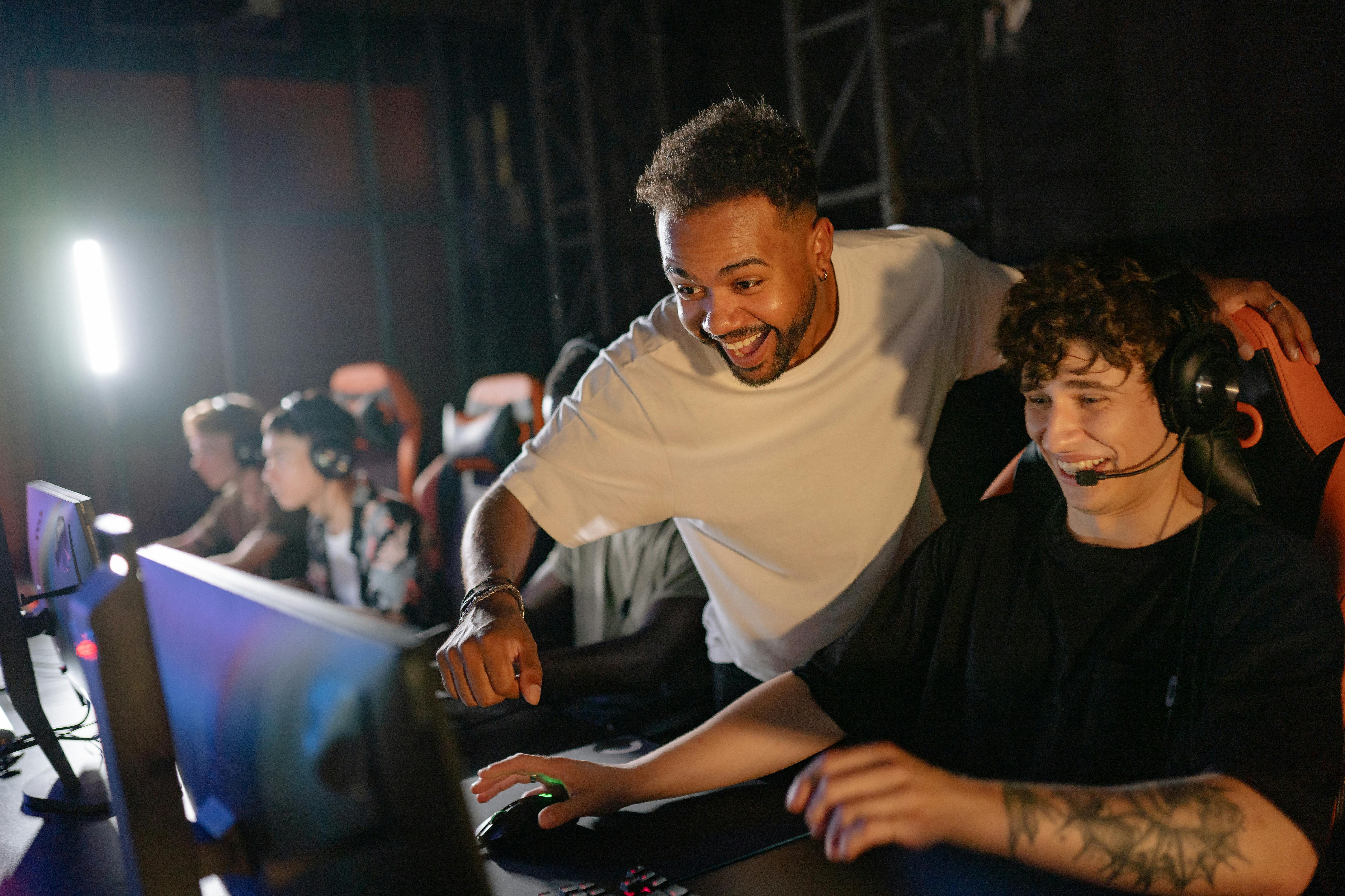 Image of man smiling and listening intently as he looks at a laptop screen.