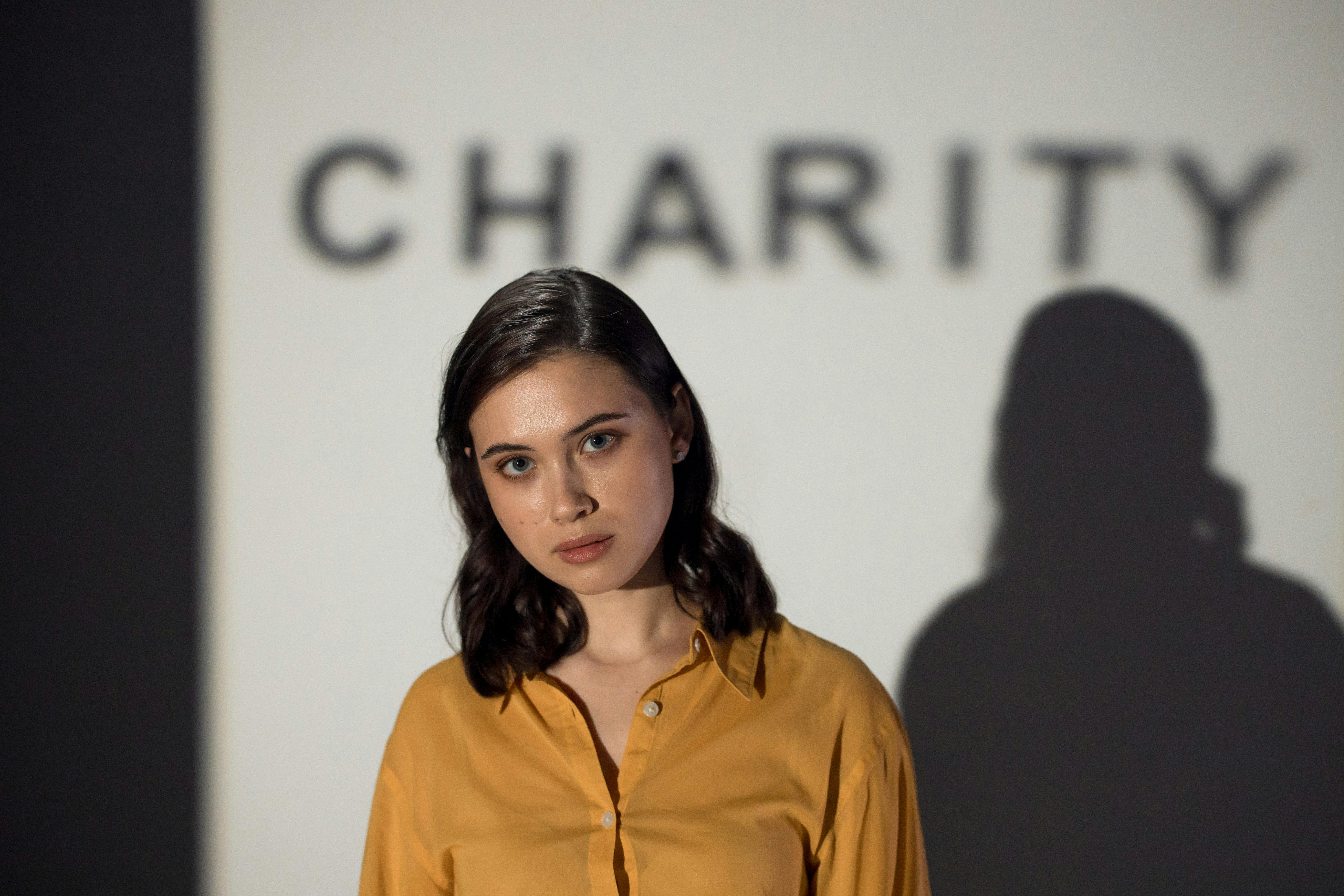 Close-up Photo of Woman in Yellow Button Up Shirt