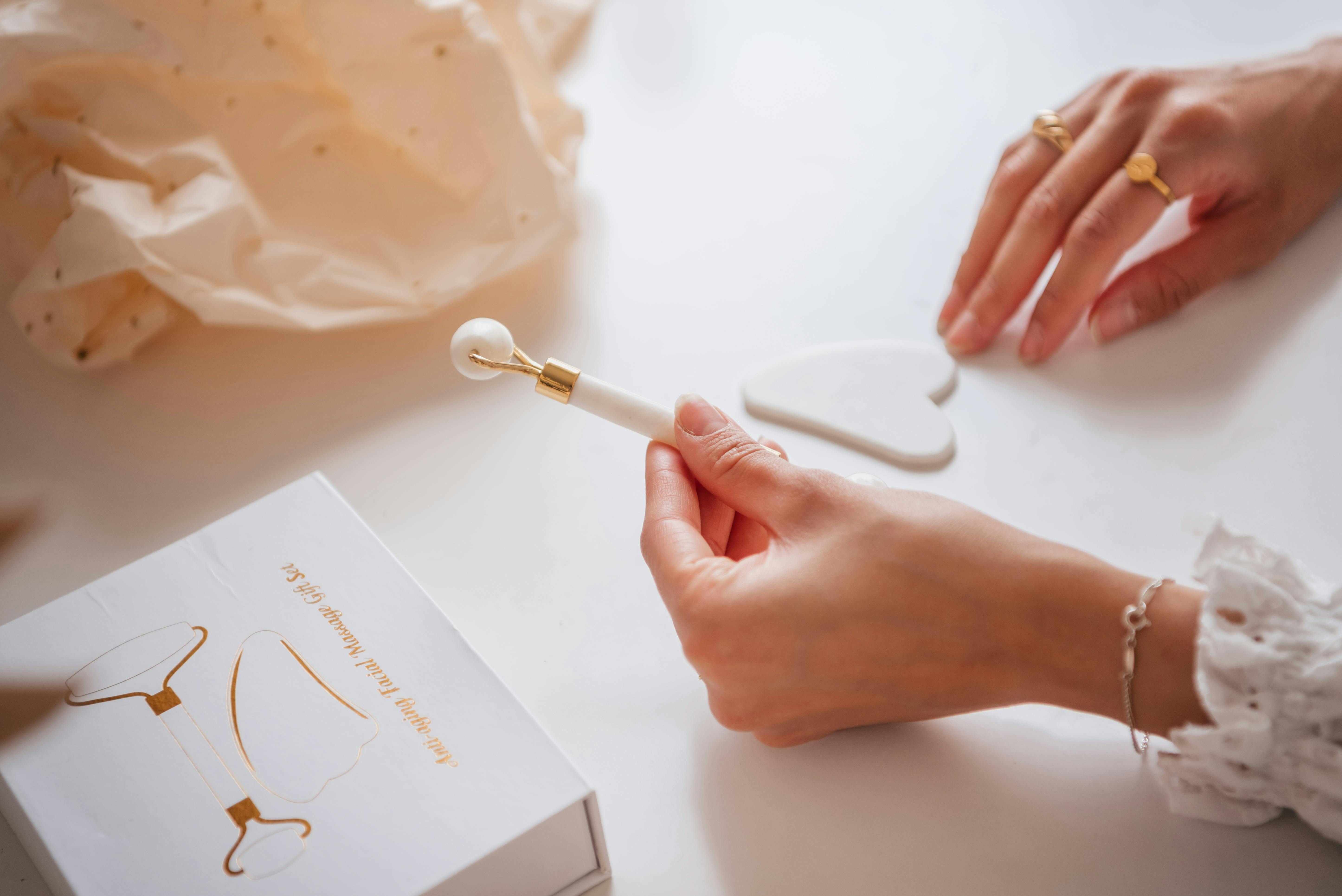 Person Holding a White Jade Roller