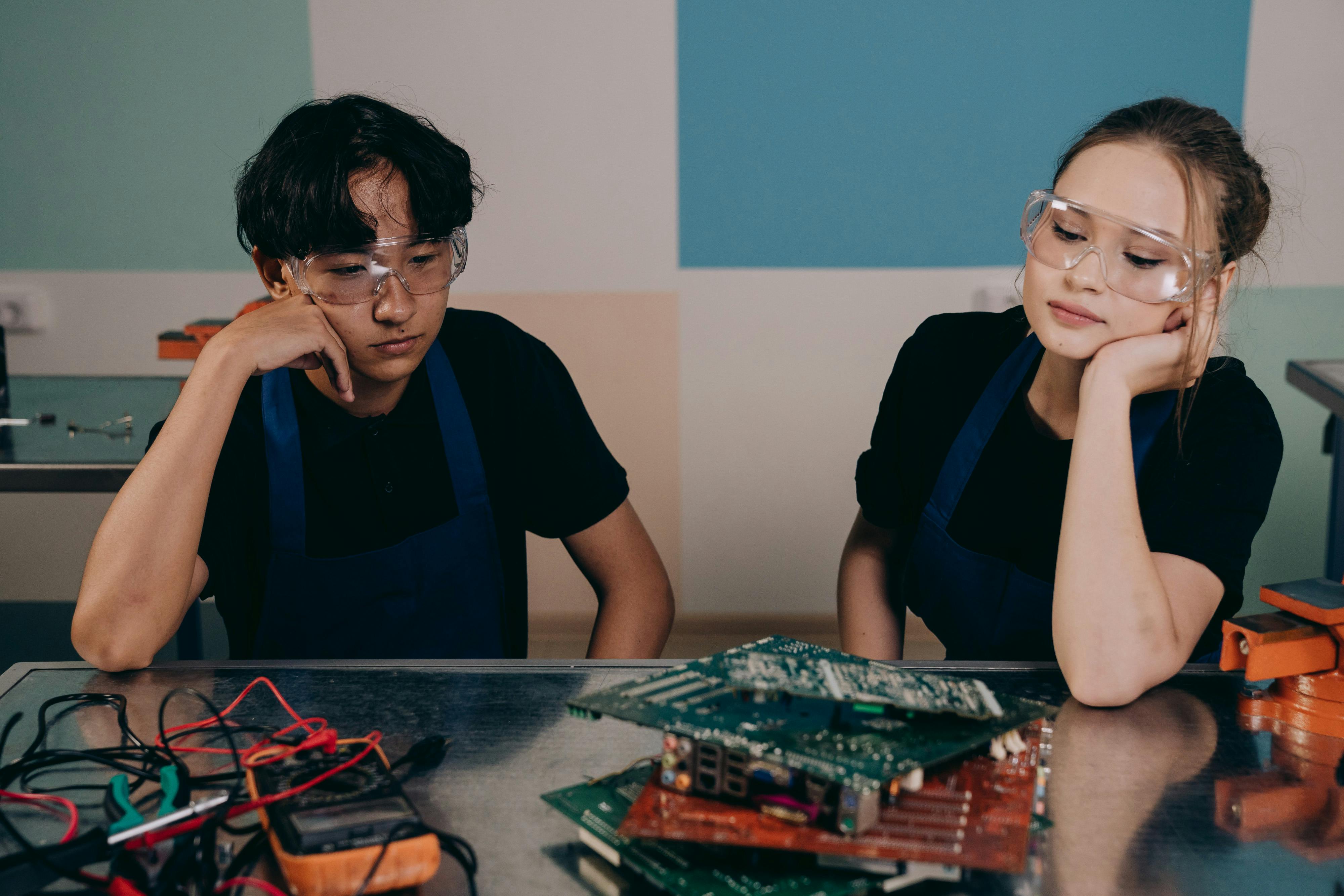 Man and Woman Looking at Motherboards