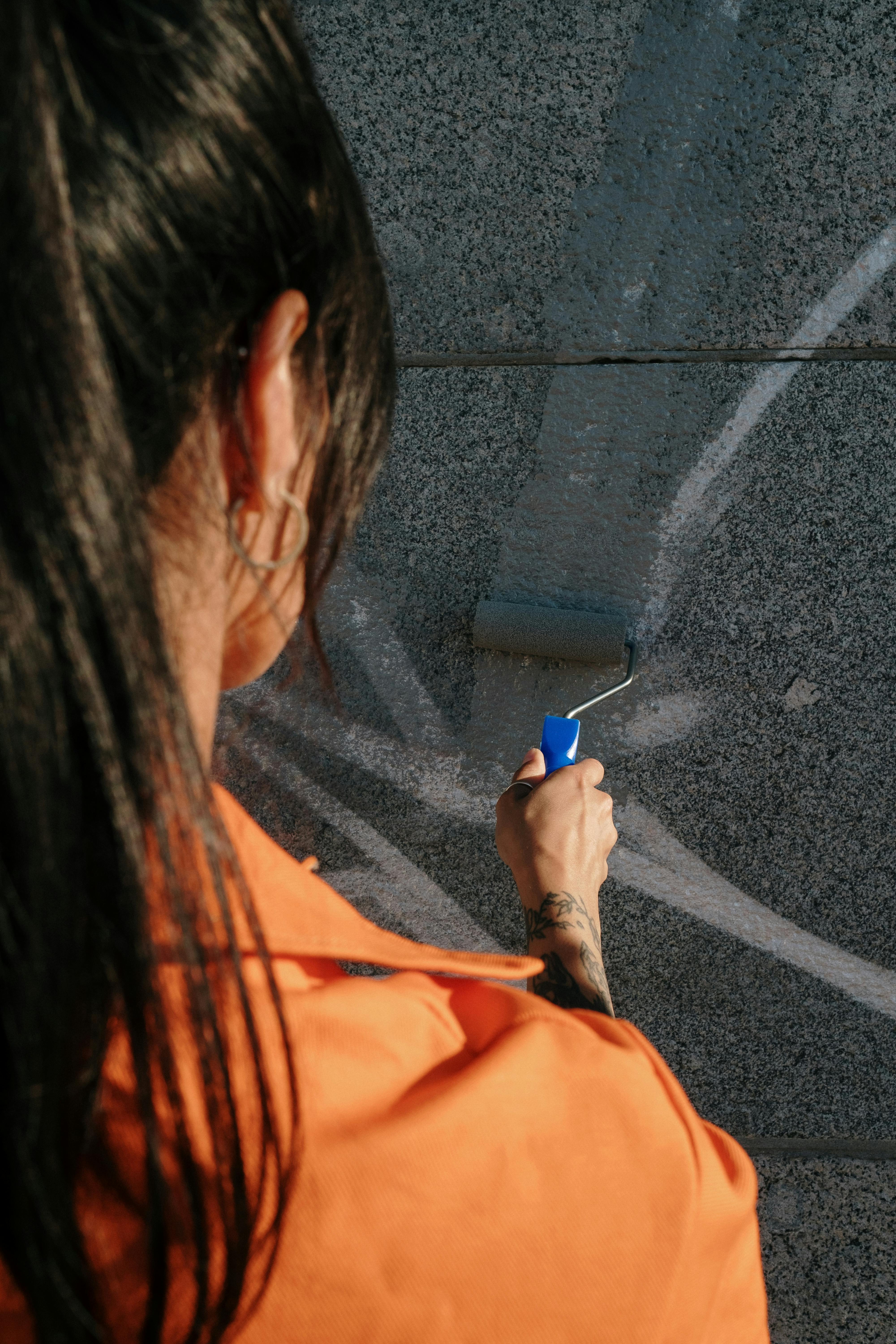 A Person Painting a Wall