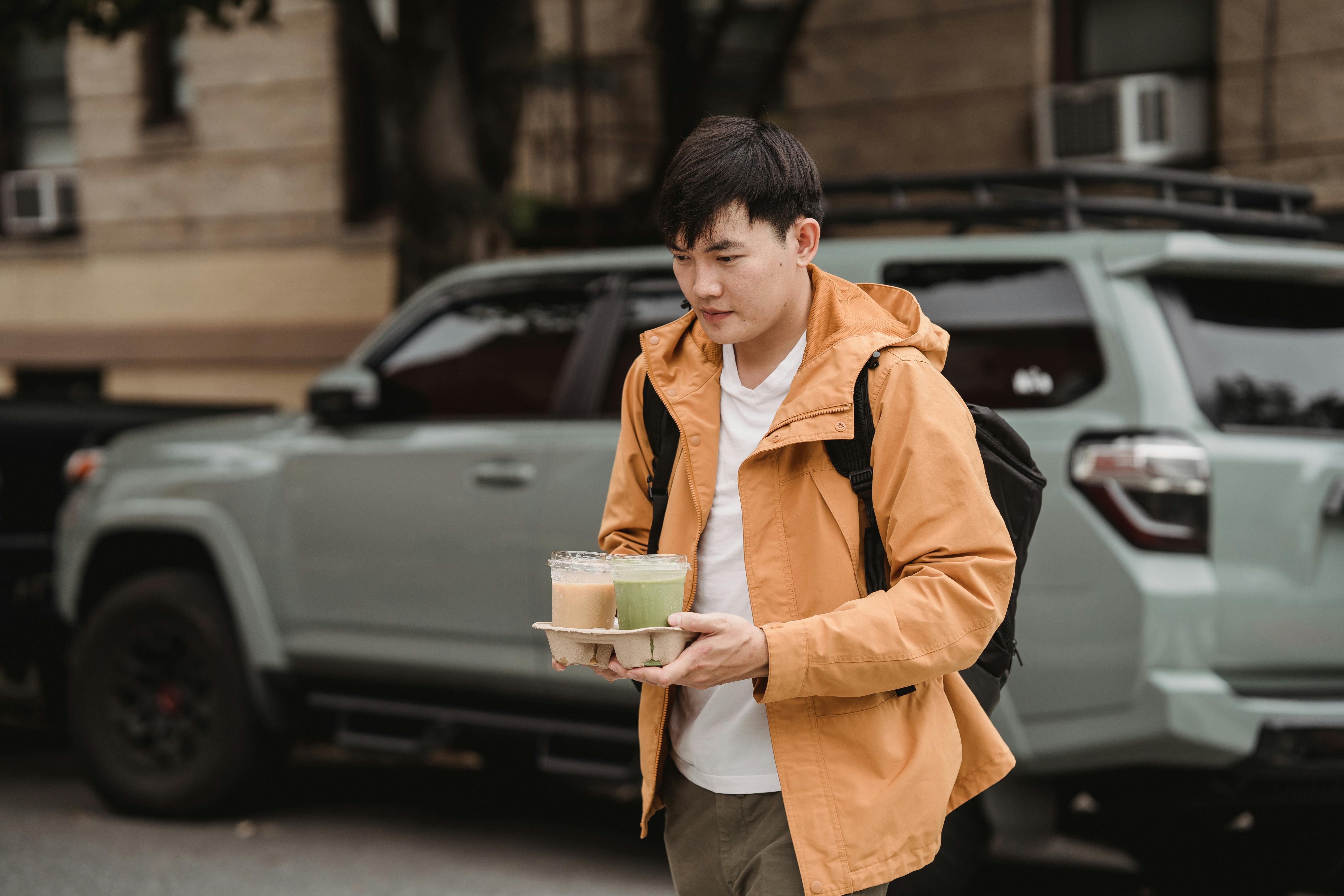 A Man in Brown Jacket Delivering Cold Beverages