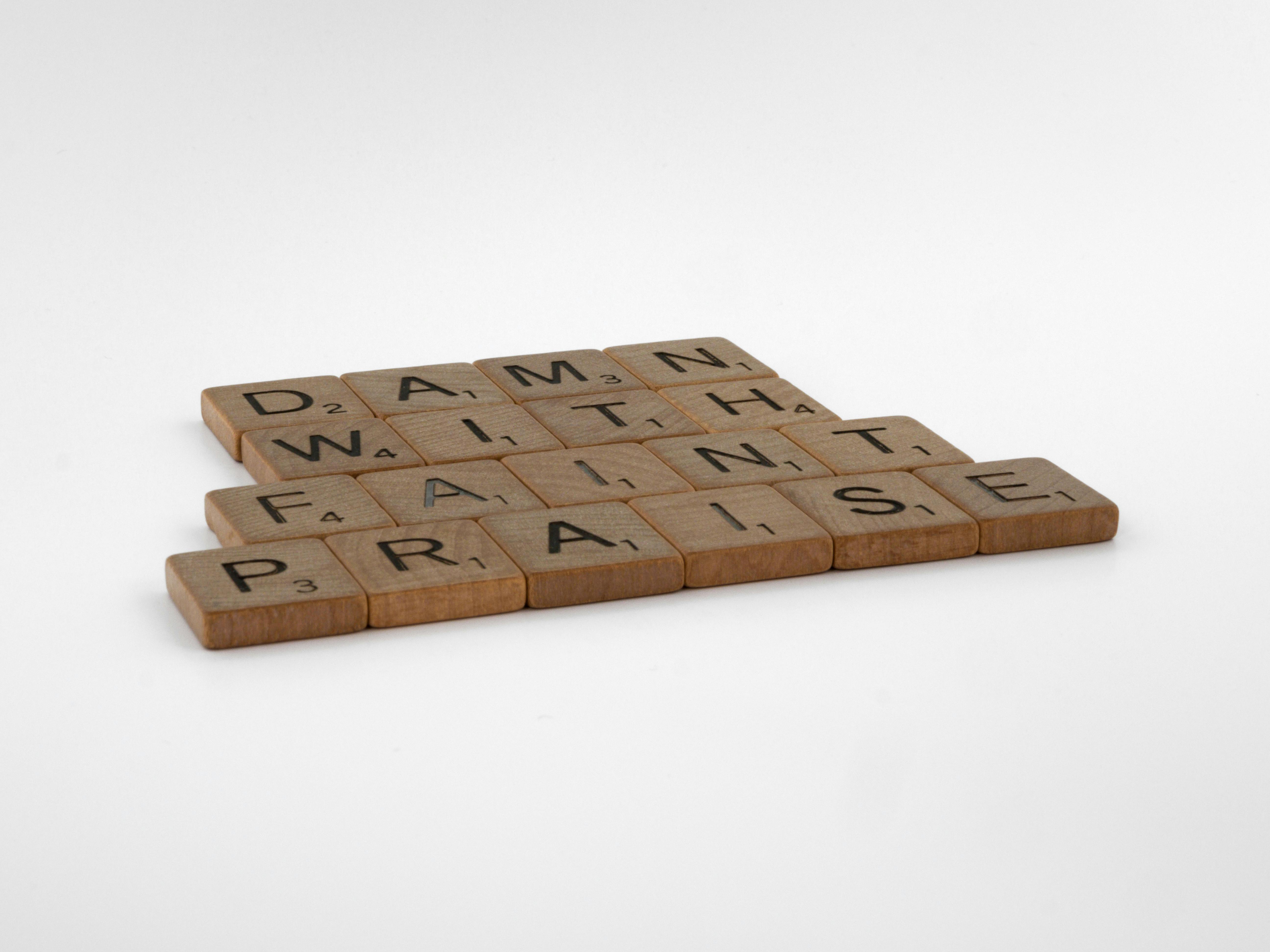 Brown Wooden Scrabble Tiles on White Background