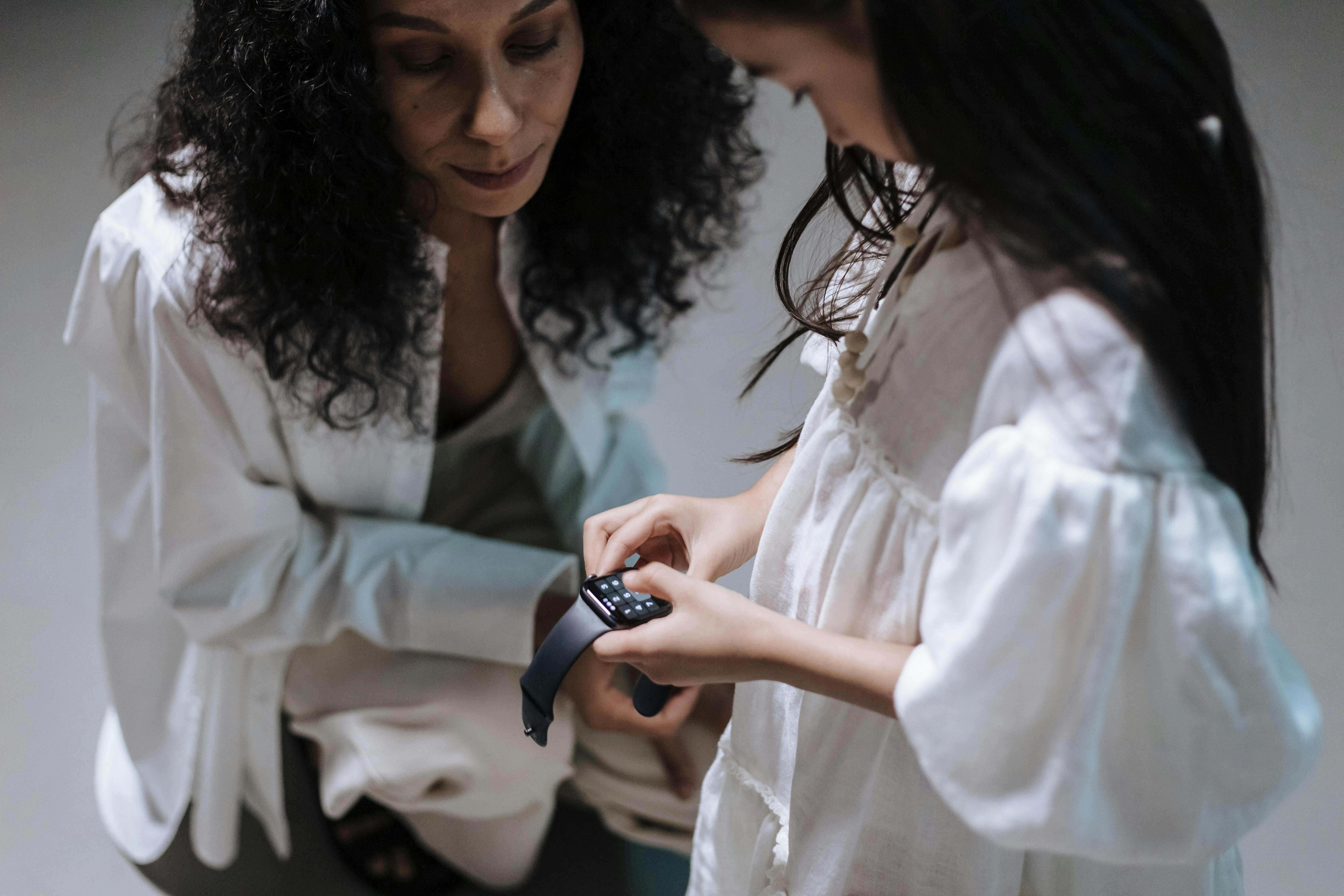 Mother and daughter with smartwatch