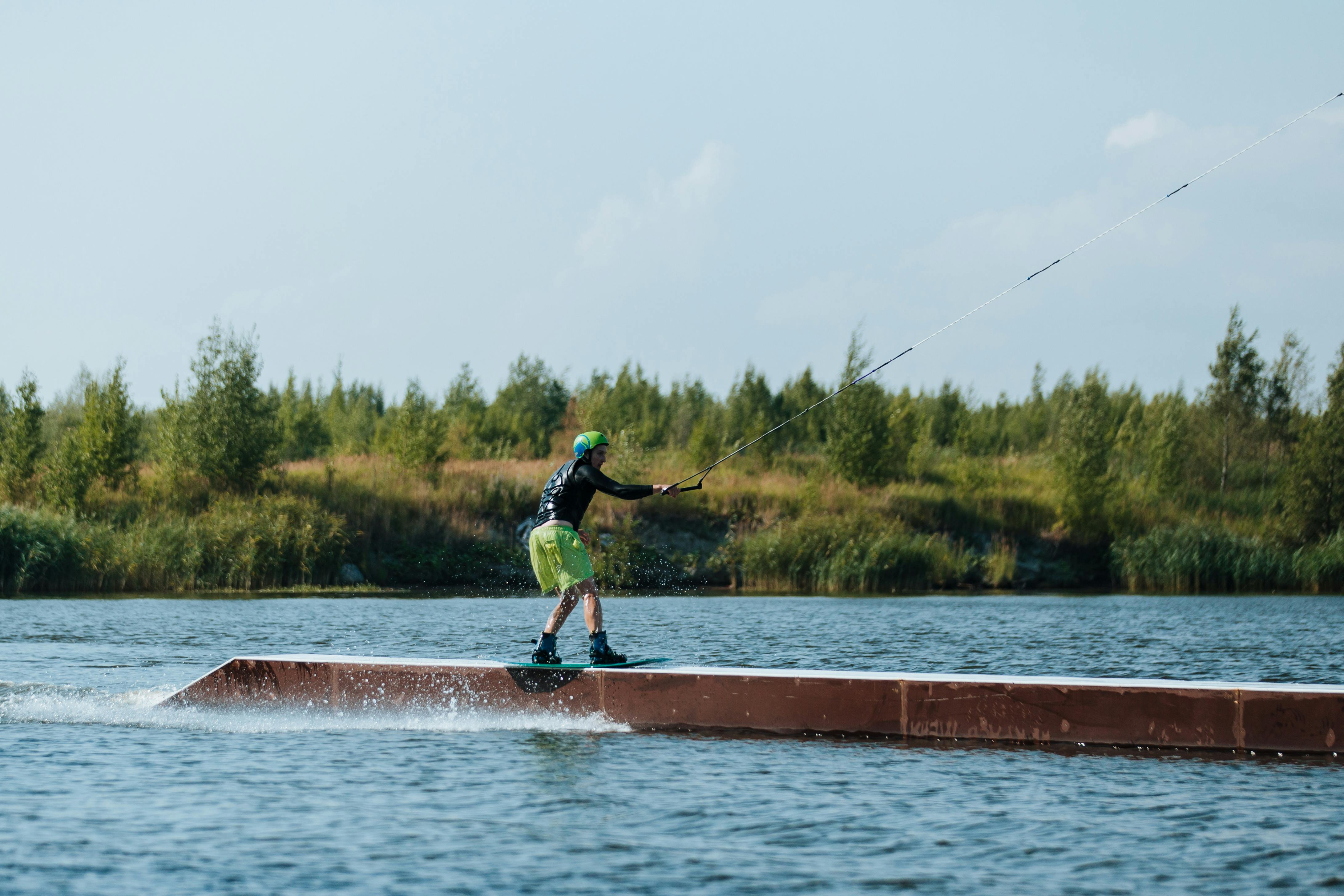A Man Doing a Wakeboarding Trick on a Lake