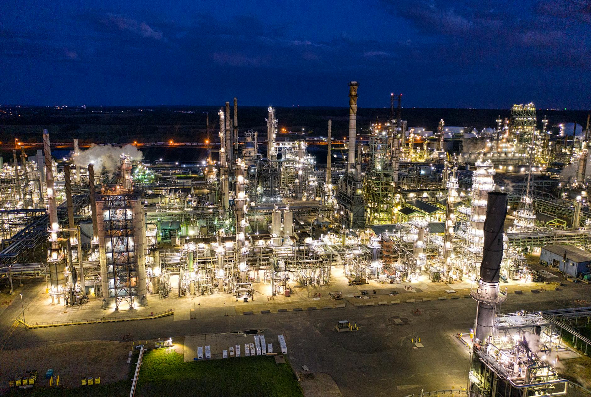 Aerial View of an Industrial Plant with Lights Turned on during Night Time