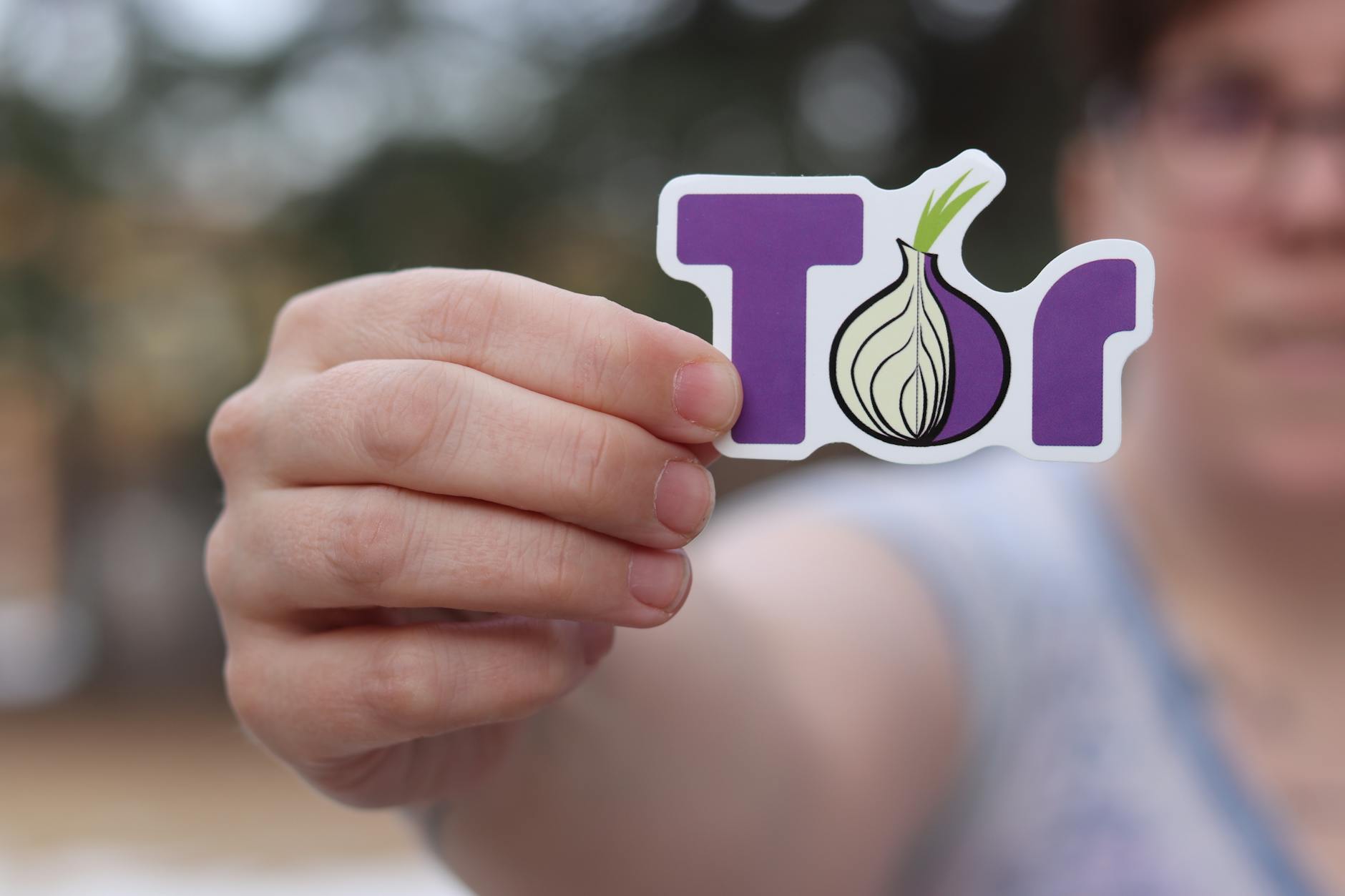 Person Holding Logo of The Onion Router