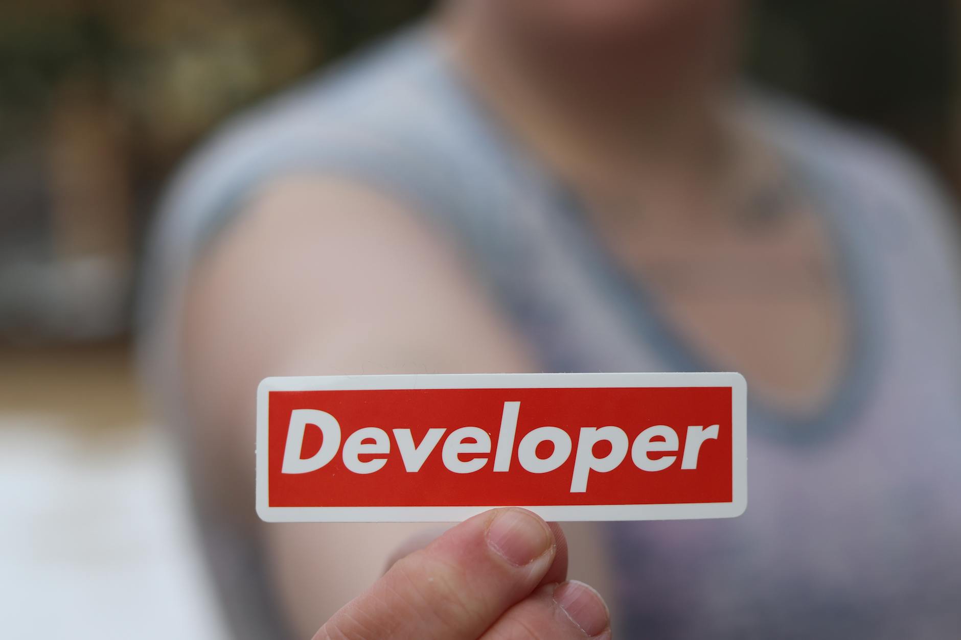 A Person Holding Red and White Card