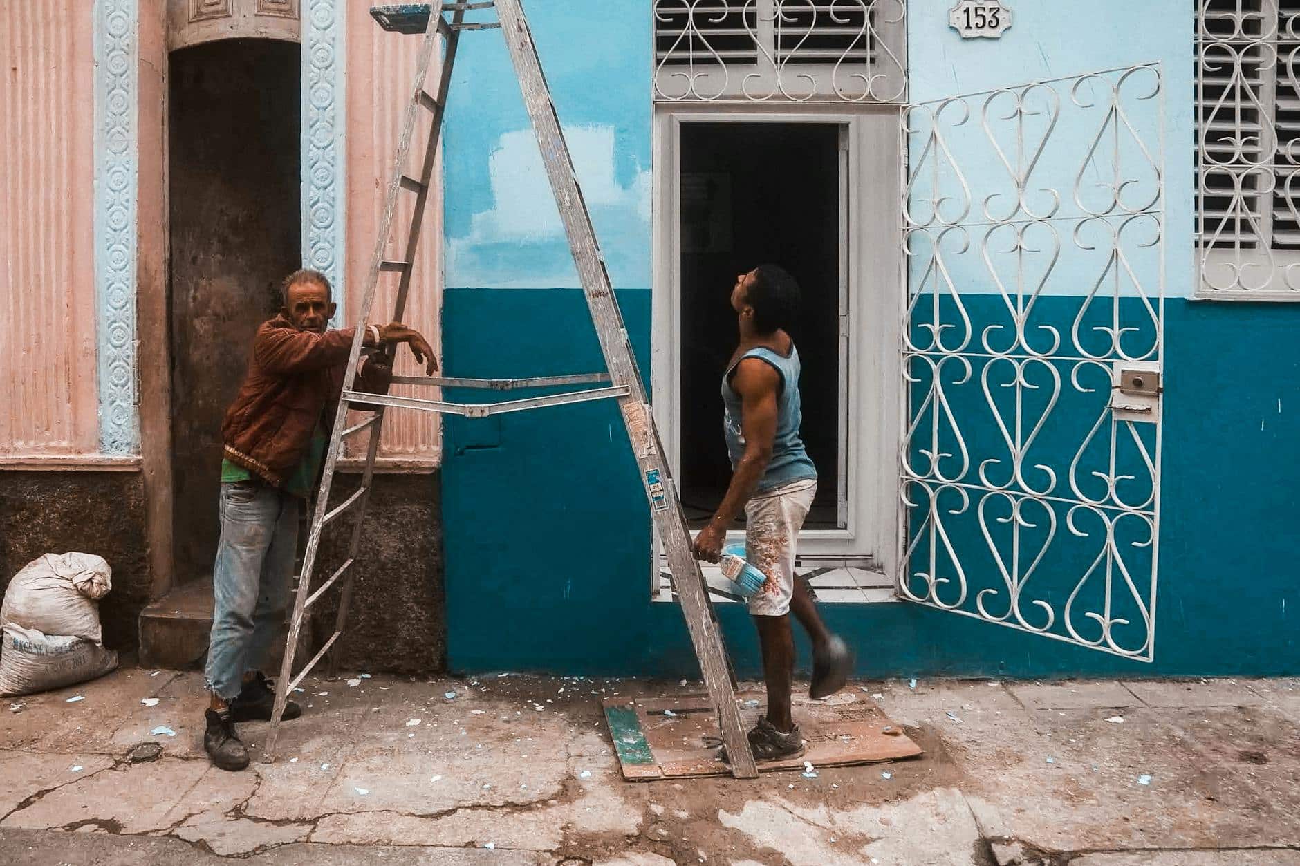 A man working on a door with a ladder