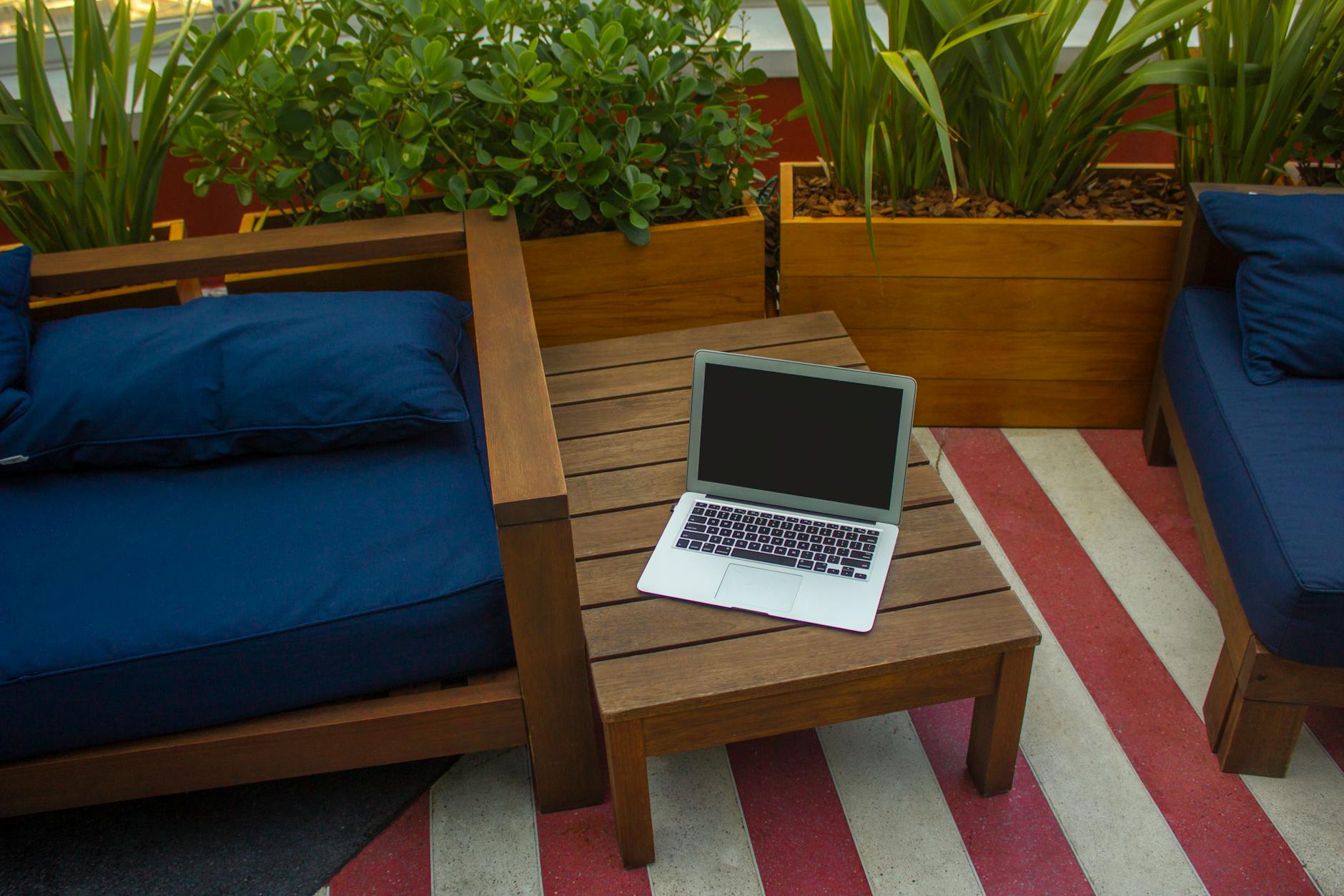 Macbook Air On Brown Wooden Table