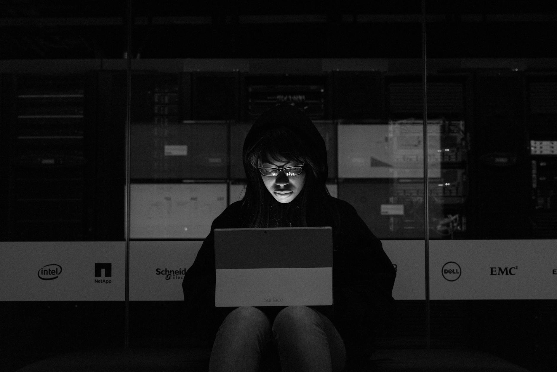 Gray scale Photograph of a Woman using a Laptop