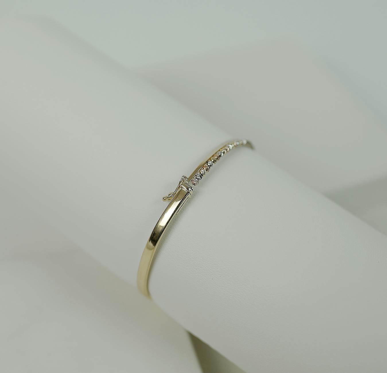 Gold Ring with Diamonds on White Surface