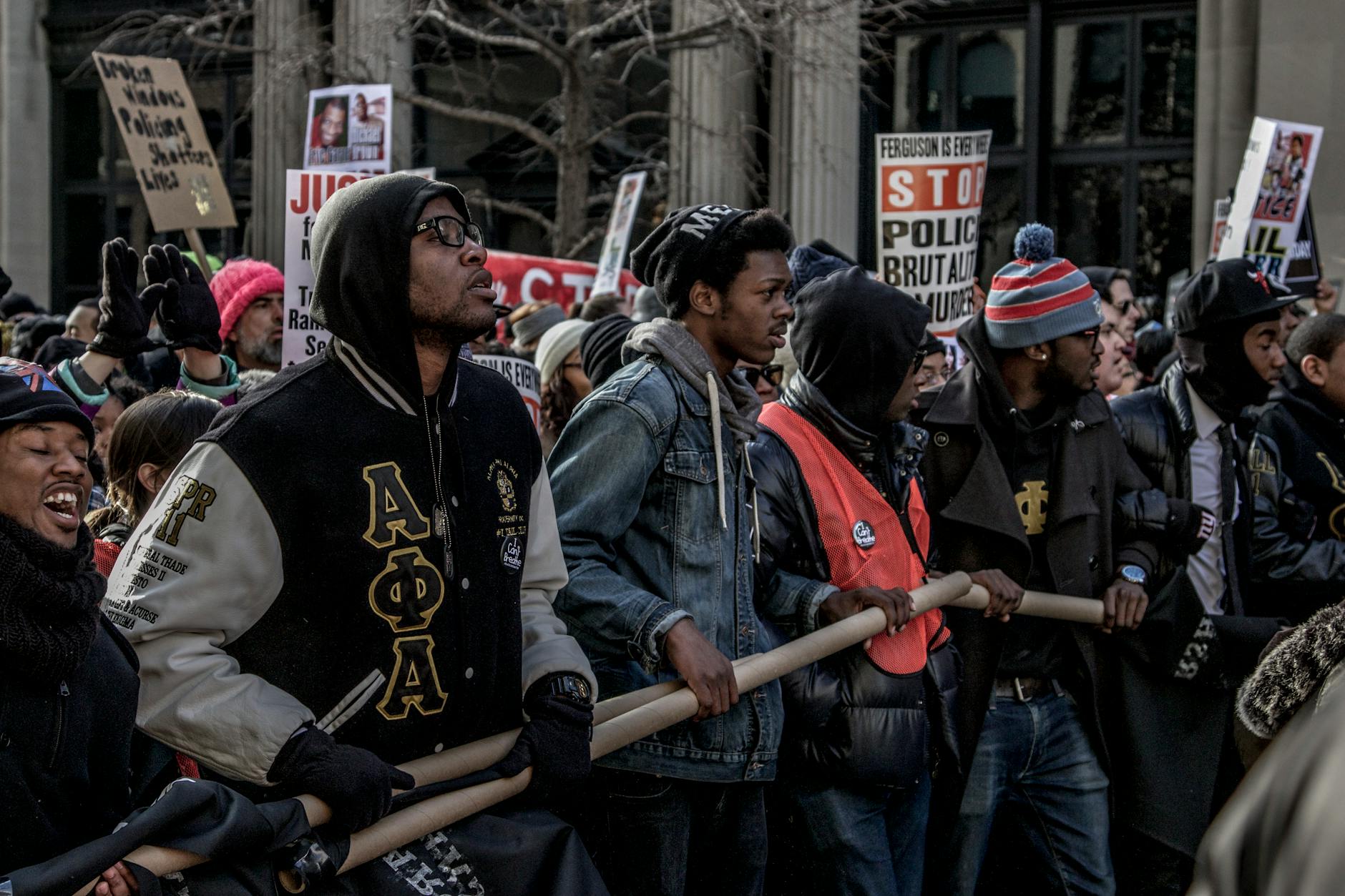 People in Black and Red Jacket Standing on Street