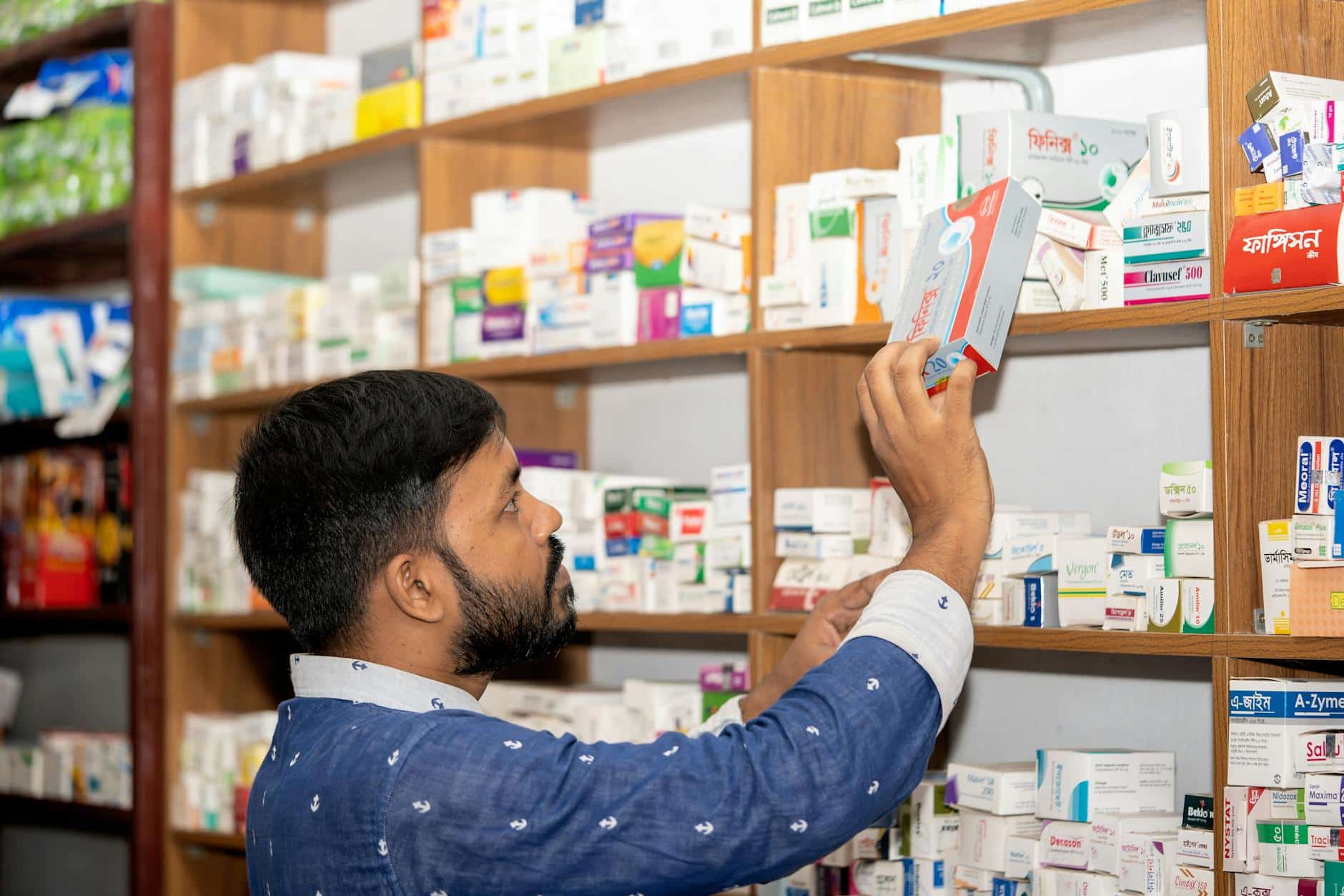 Professional pharmacist in modern drugstore, space for text