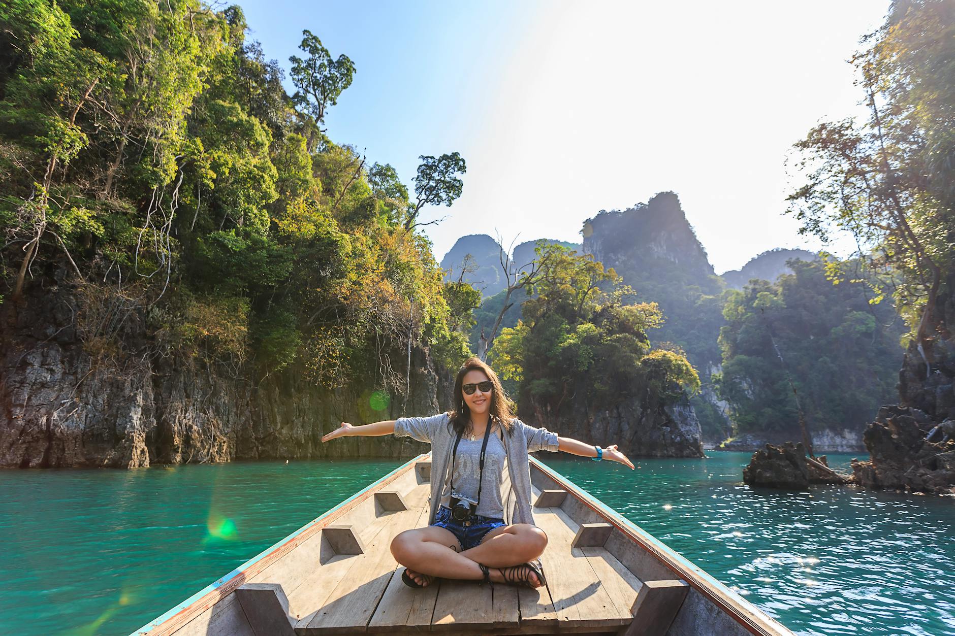 Woman Sitting on Boat Spreading Her Arms