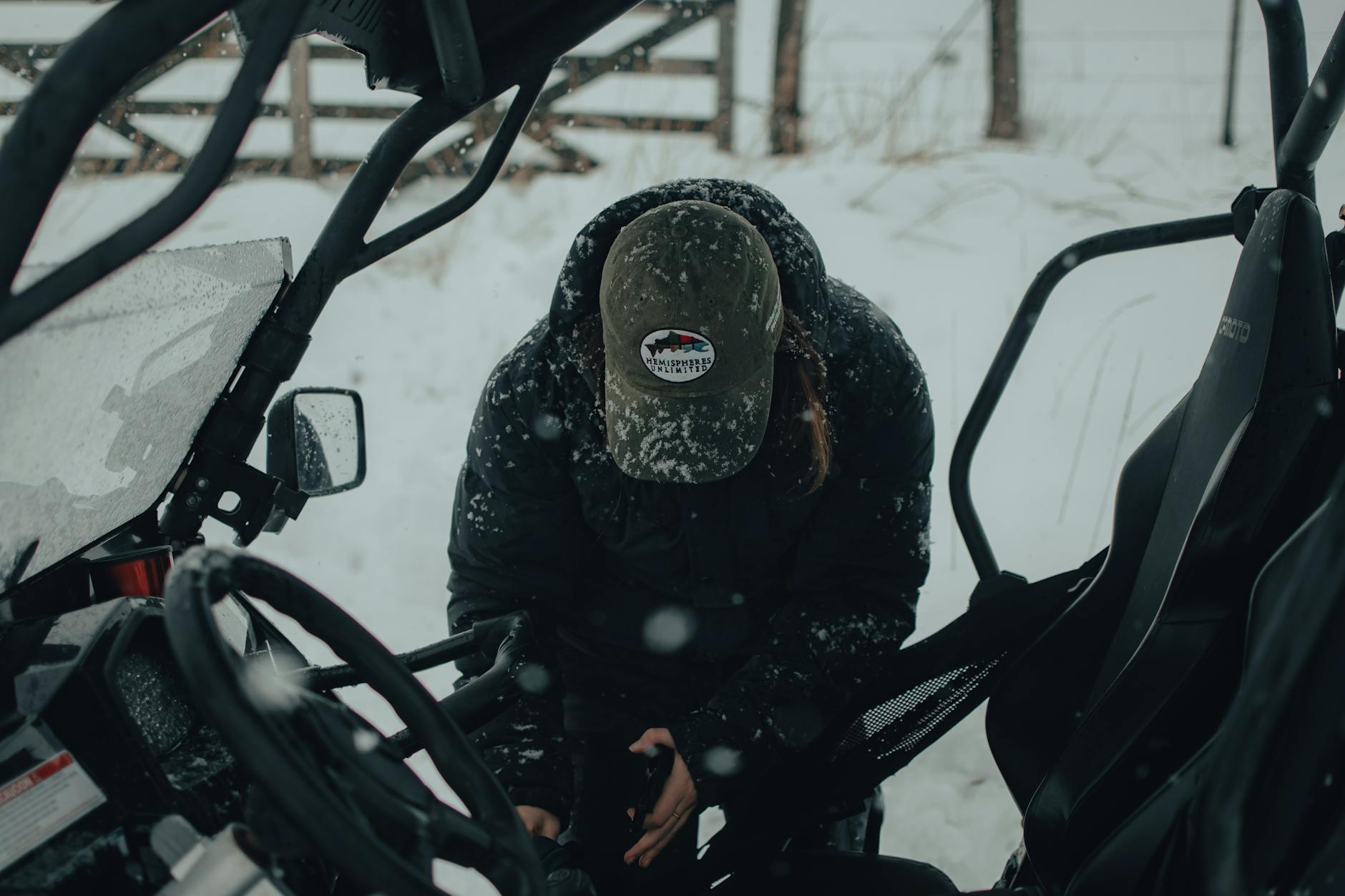 Man Standing on Snow outside Tractor