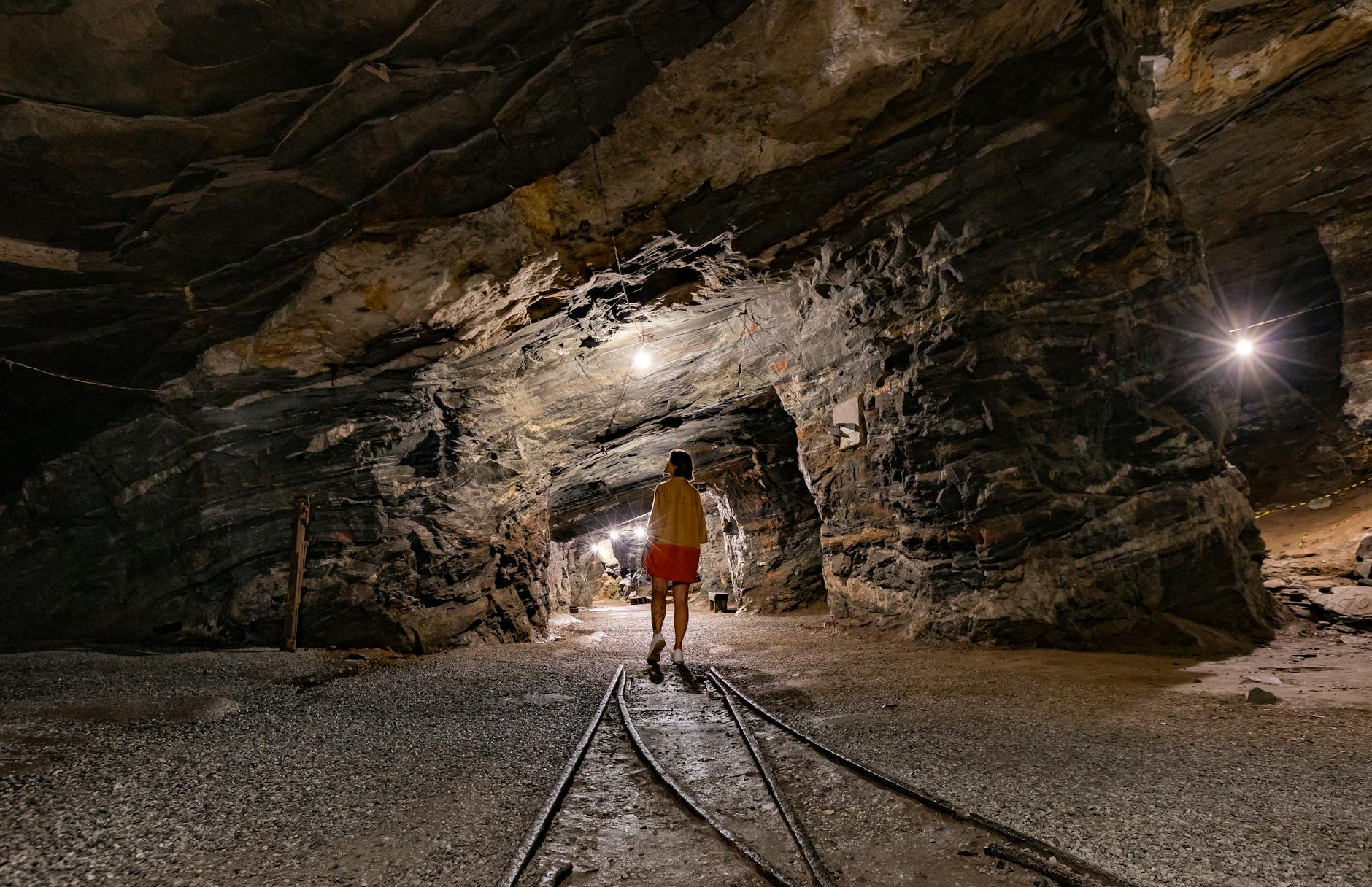 A Person Walking in an Underground Mine