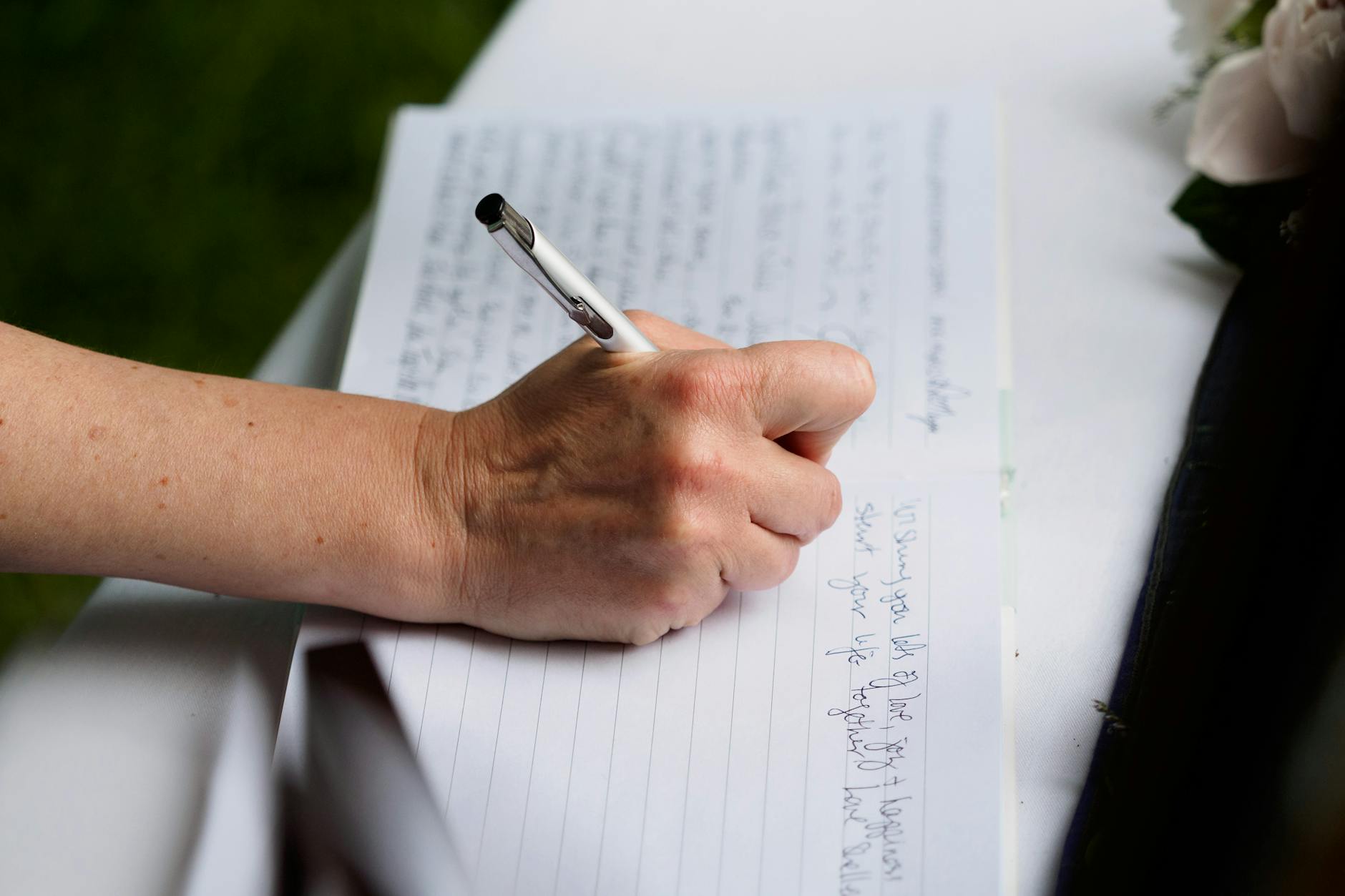 Close-Up Shot of a Person Writing on Notebook Using a Pen
