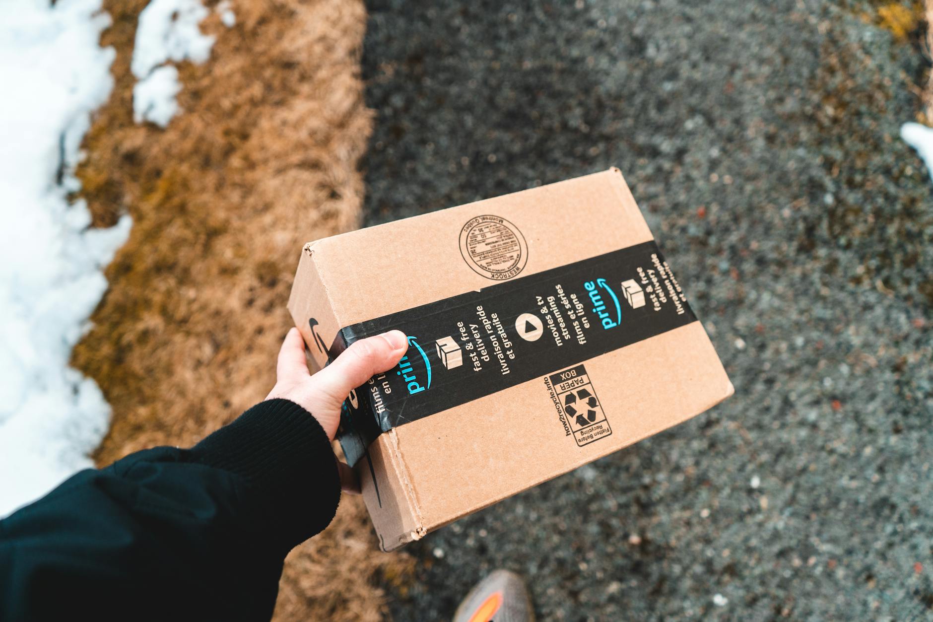 A diverse range of packages and boxes being loaded onto a truck for delivery.