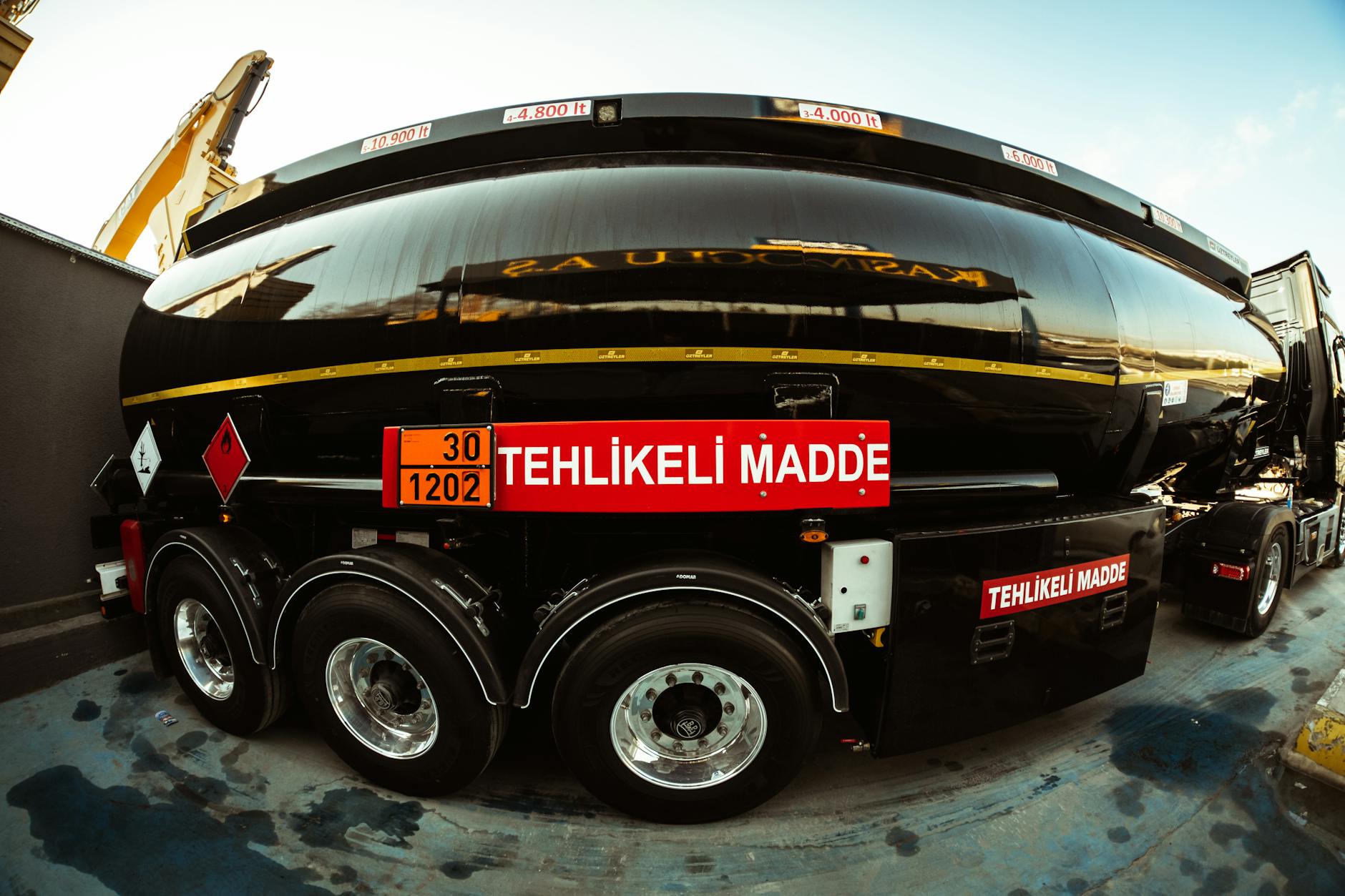 A Fish Eye Shot of a Large Black Tank Truck