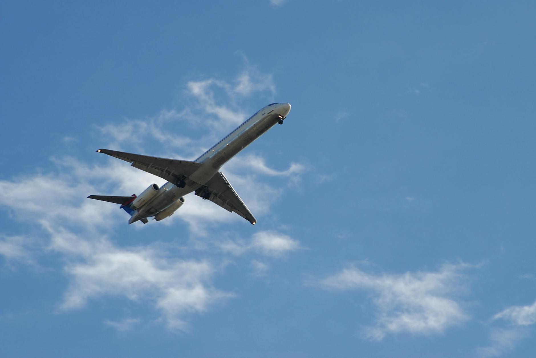 White and Blue Airplane Under White and Blue Sky during Daytime