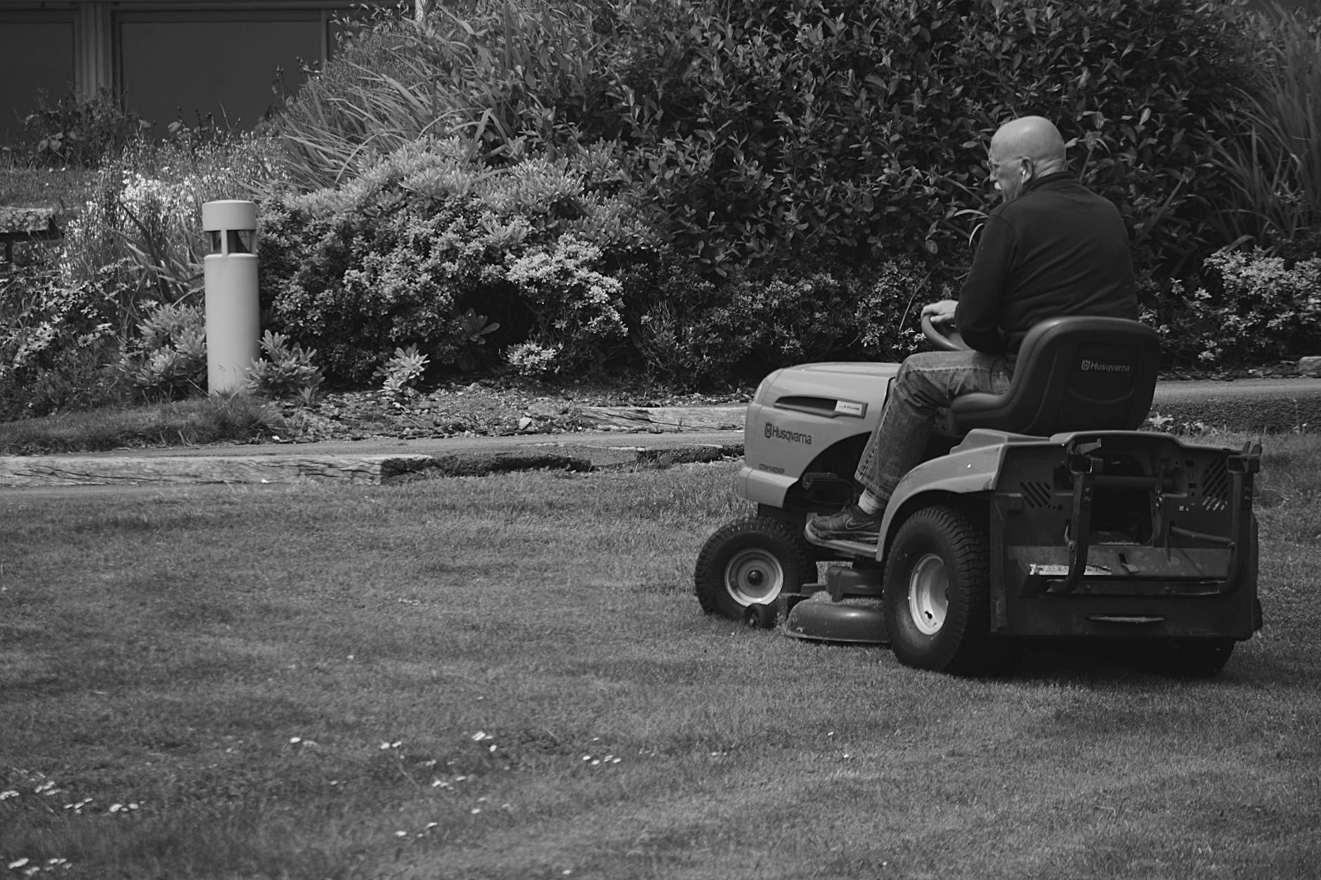 Man Riding a Lawn Mower Vehicle